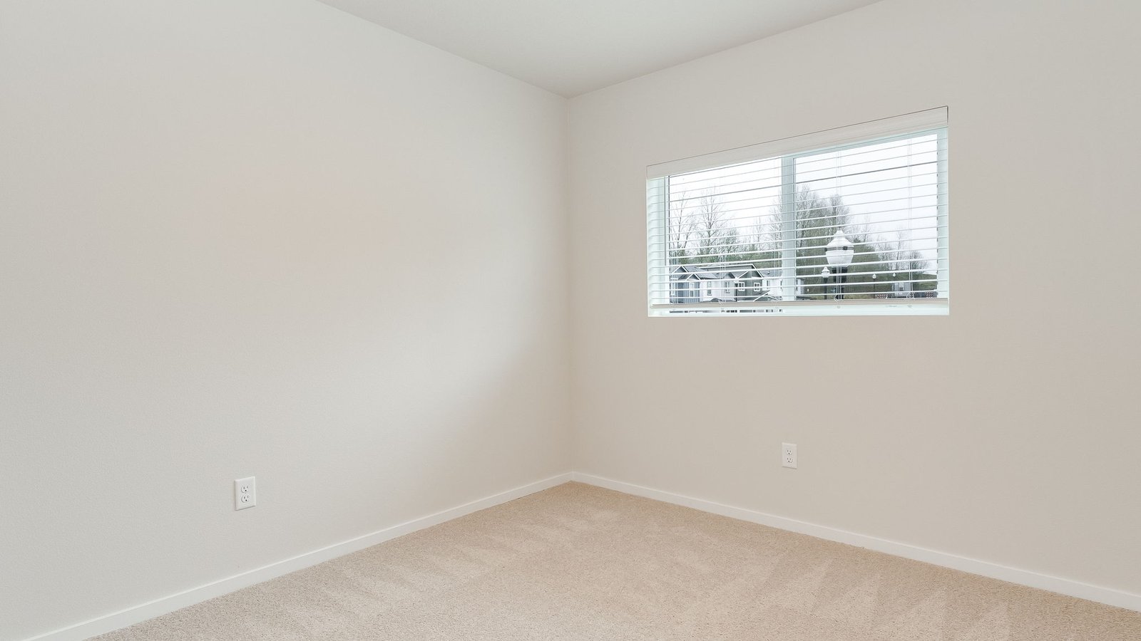 Bedroom with wall-to-wall carpet and a closet