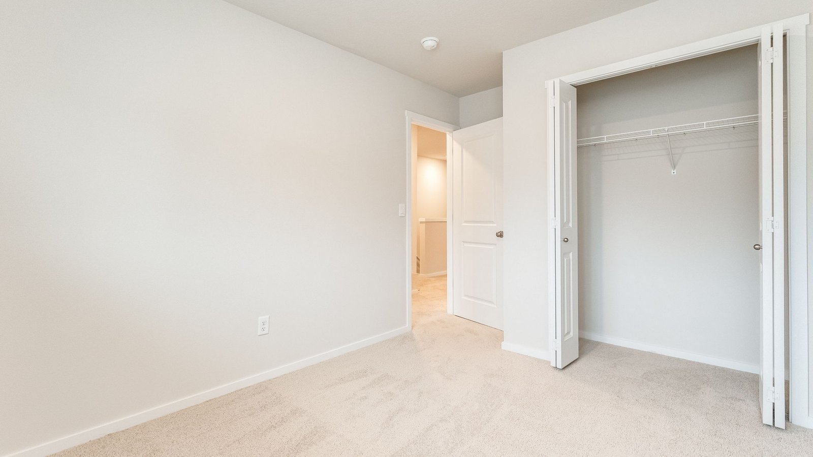 Bedroom with wall-to-wall carpet and a closet
