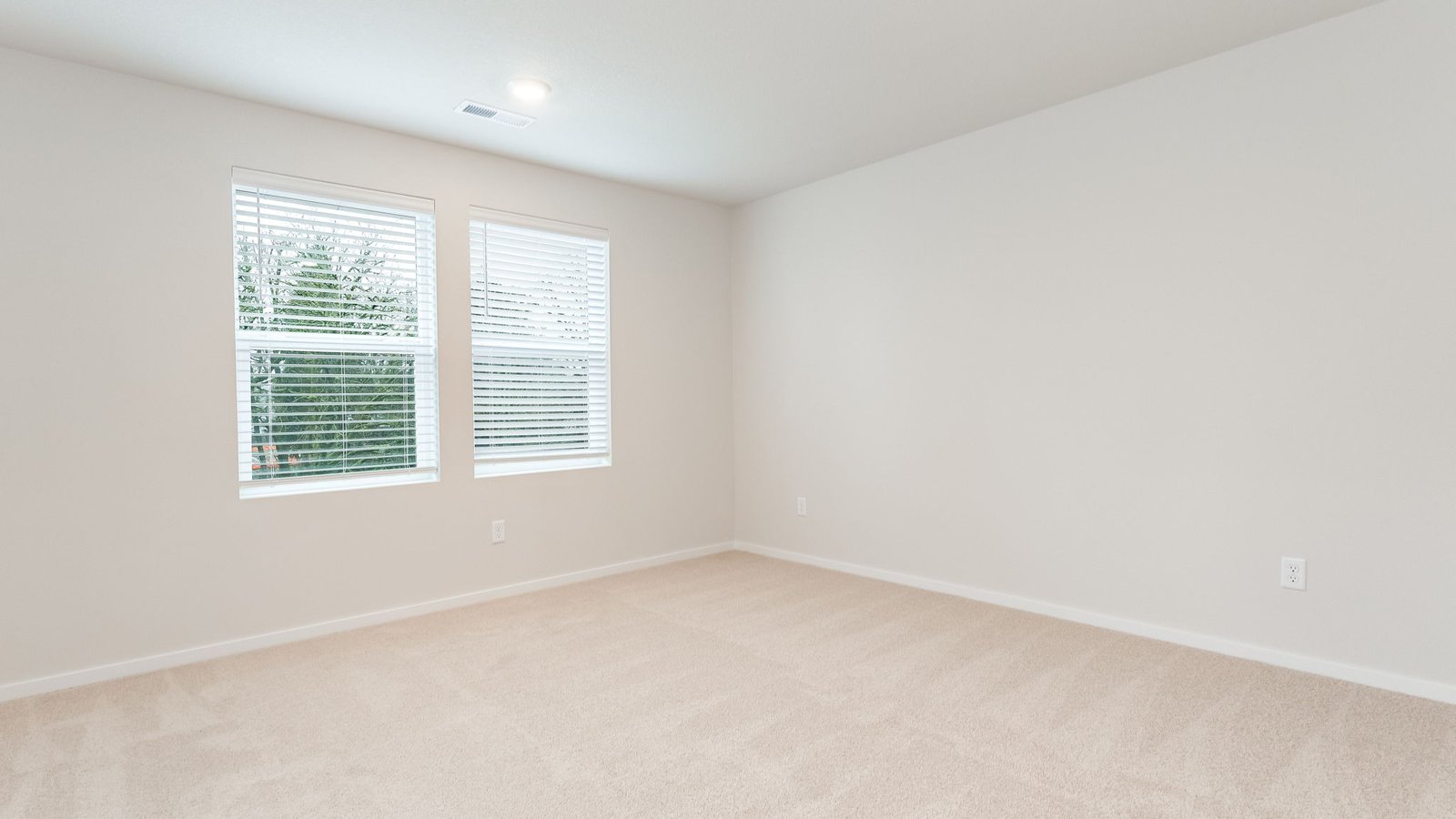 Primary bedroom with wall-to-wall carpet, a walk-in closet and an attached bathroom