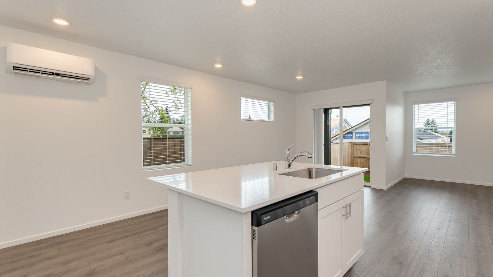 Kitchen with shaker cabinets, quartz counters, stainless steel appliances, pantry, and an island with a breakfast bar