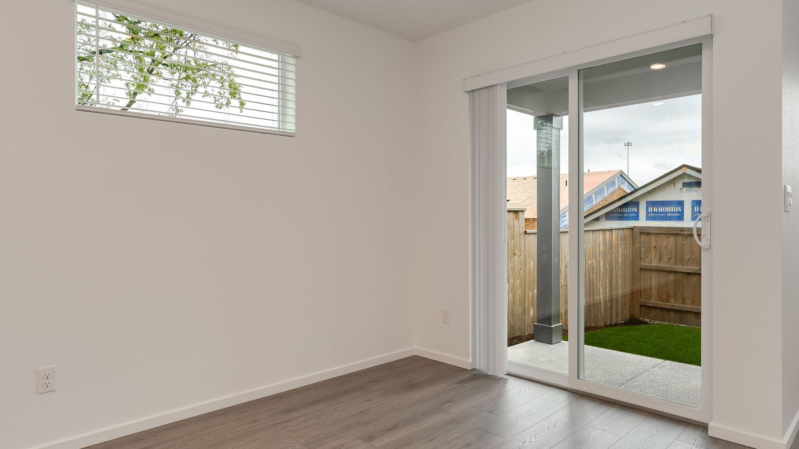 Dining area with a sliding glass door to a fenced backyard
