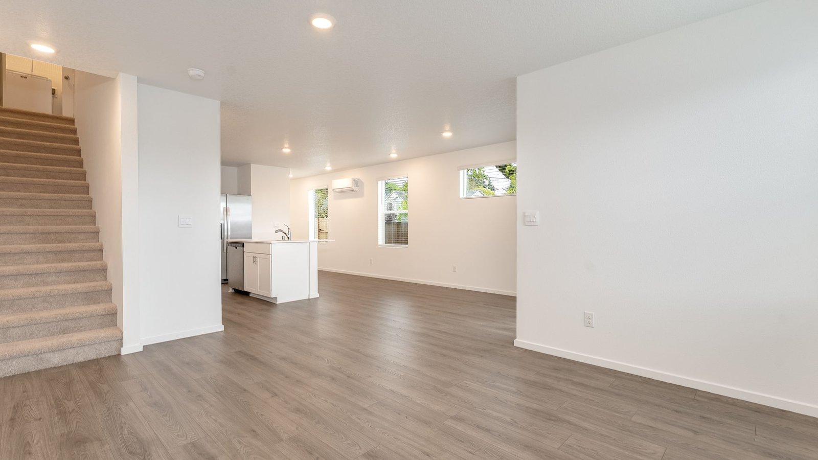 Great room with laminate flooring and an electric fireplace