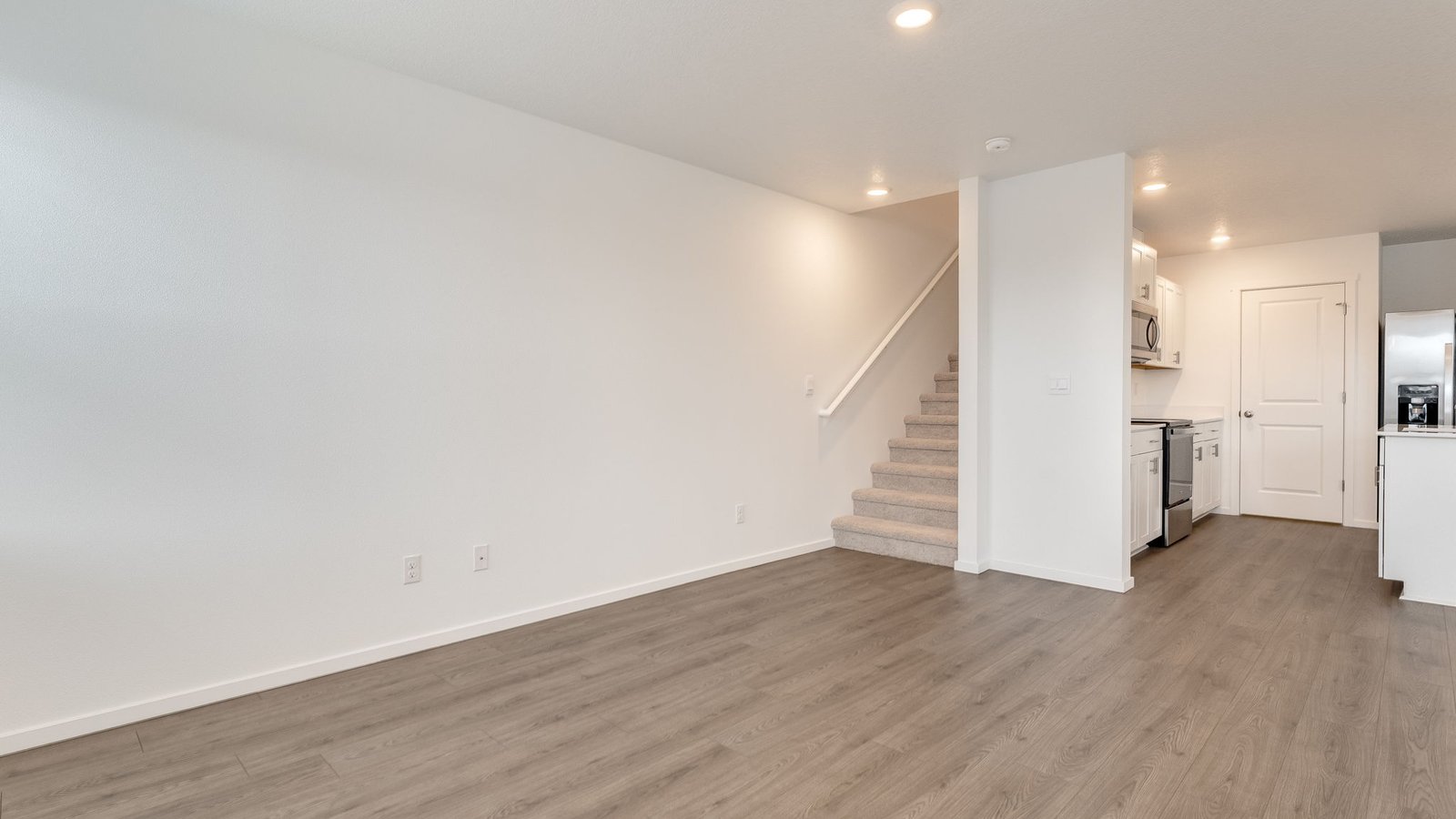 Great room with laminate flooring and an electric fireplace