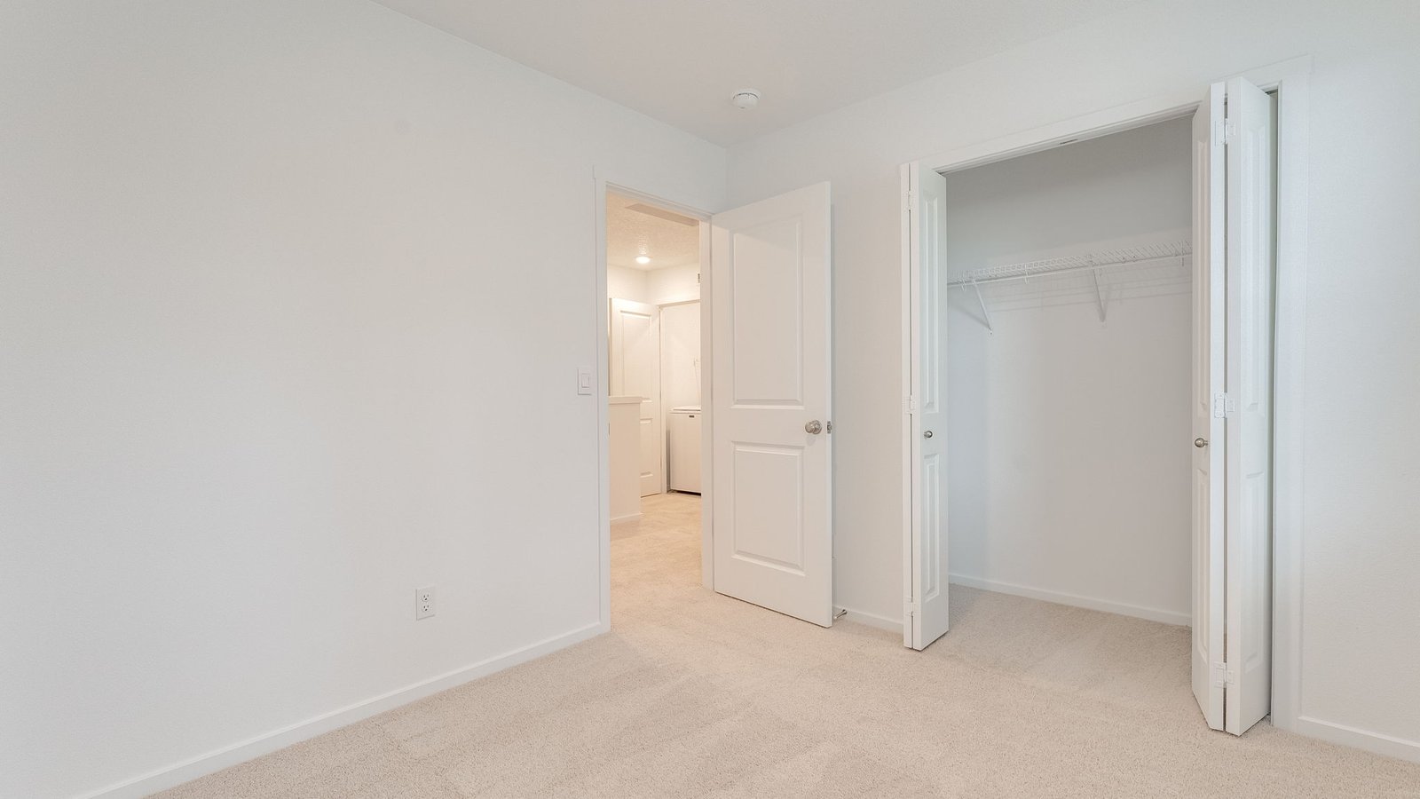 Bedroom with wall-to-wall carpet and a closet
