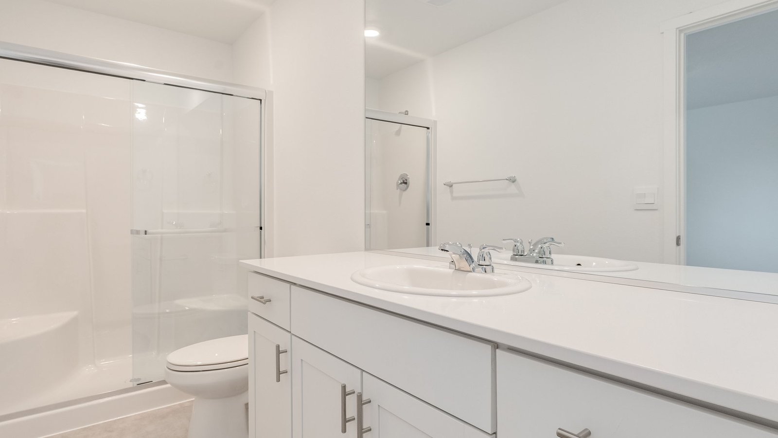 Primary bathroom with quartz counters and a walk-in shower