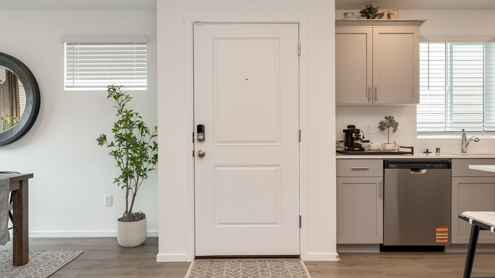 Entryway with a coat closet and laminate flooring