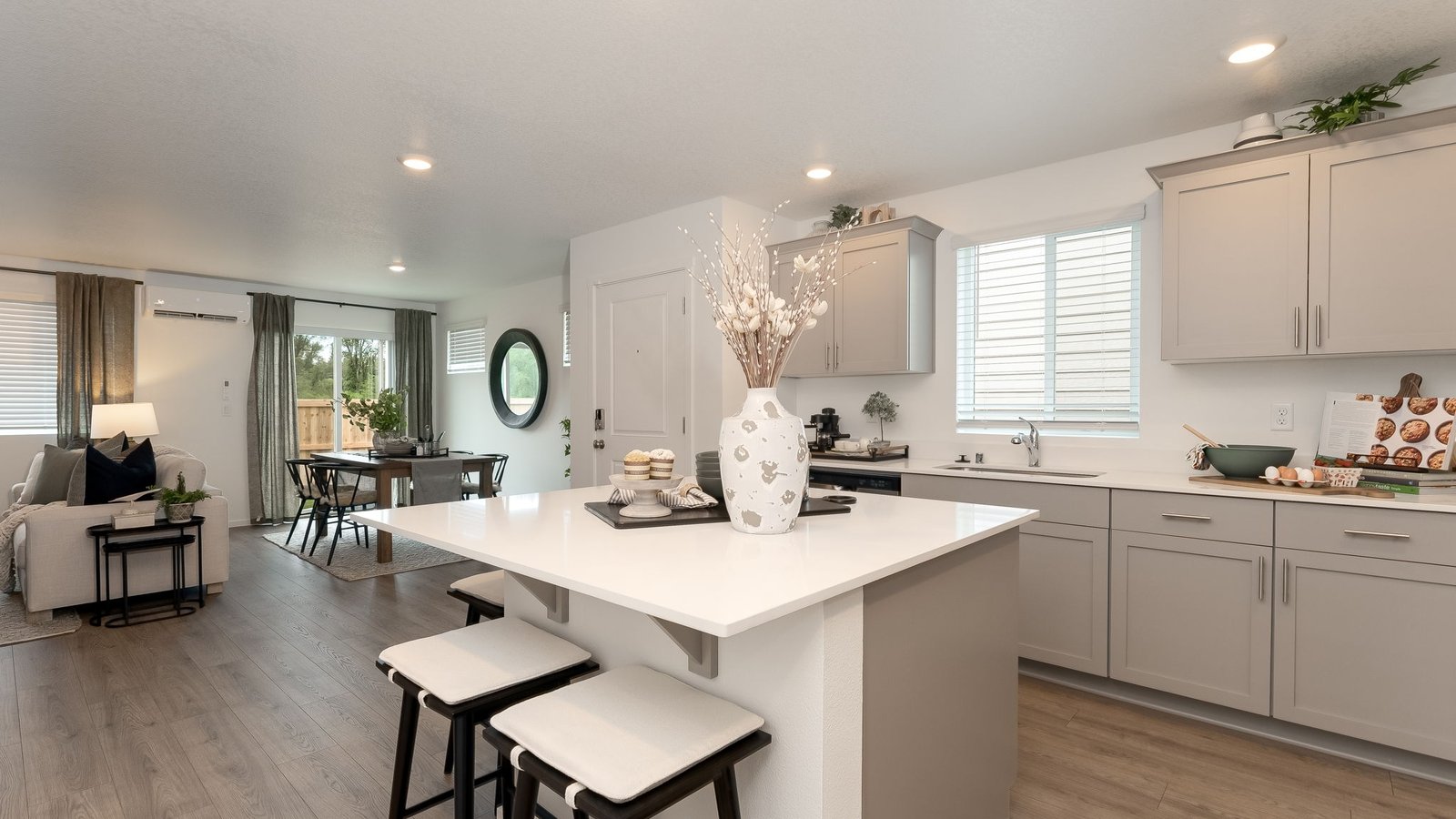 Kitchen with shaker cabinets, quartz counters, stainless steel appliances, pantry, and an island with a breakfast bar