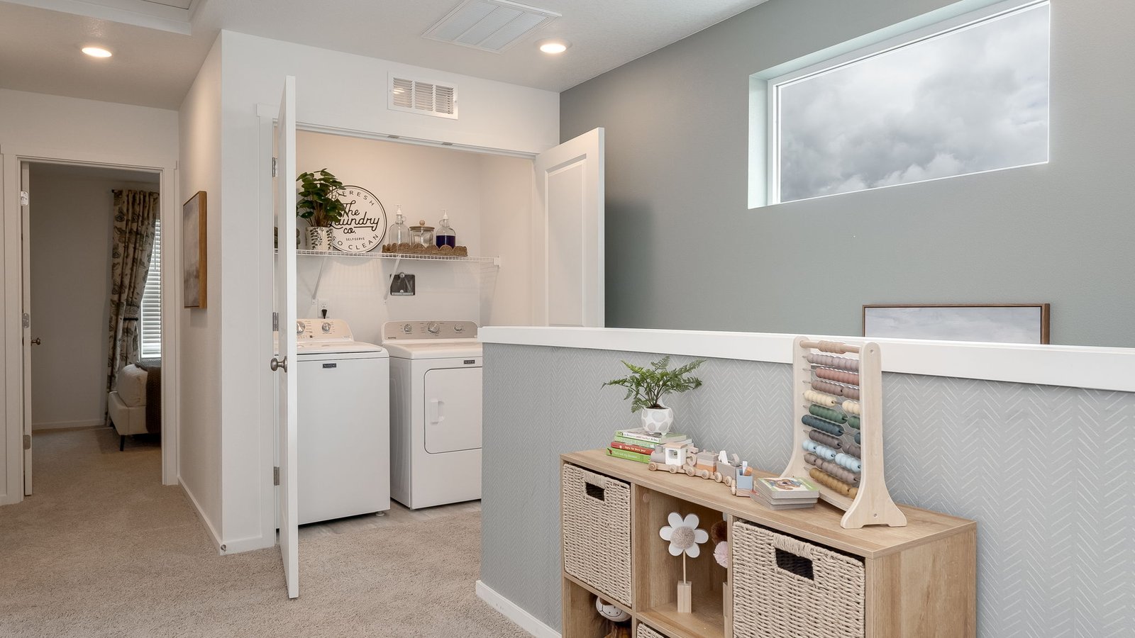 Laundry closet with wire shelves and washer and dryer hookups