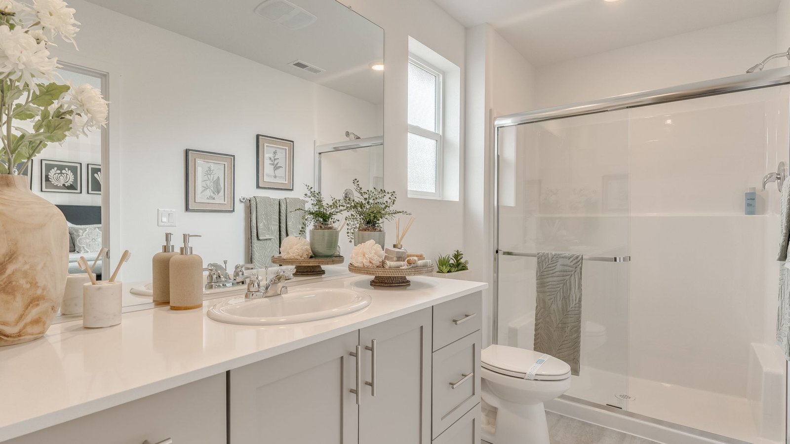 Primary bathroom with quartz counters and a walk-in shower