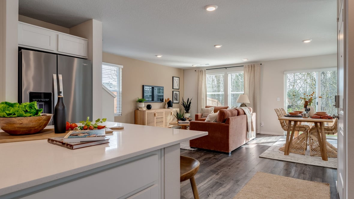 Kitchen with shaker cabinets, quartz counters, stainless steel appliances, pantry, and an island with a breakfast bar