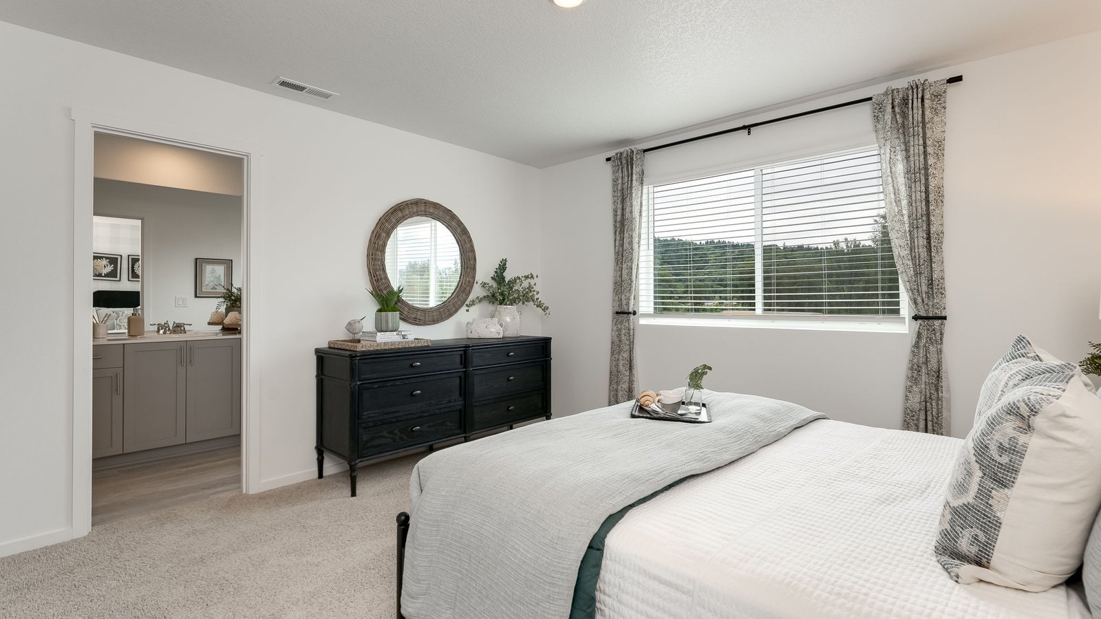 Primary bedroom with wall-to-wall carpet, a walk-in closet and an attached bathroom