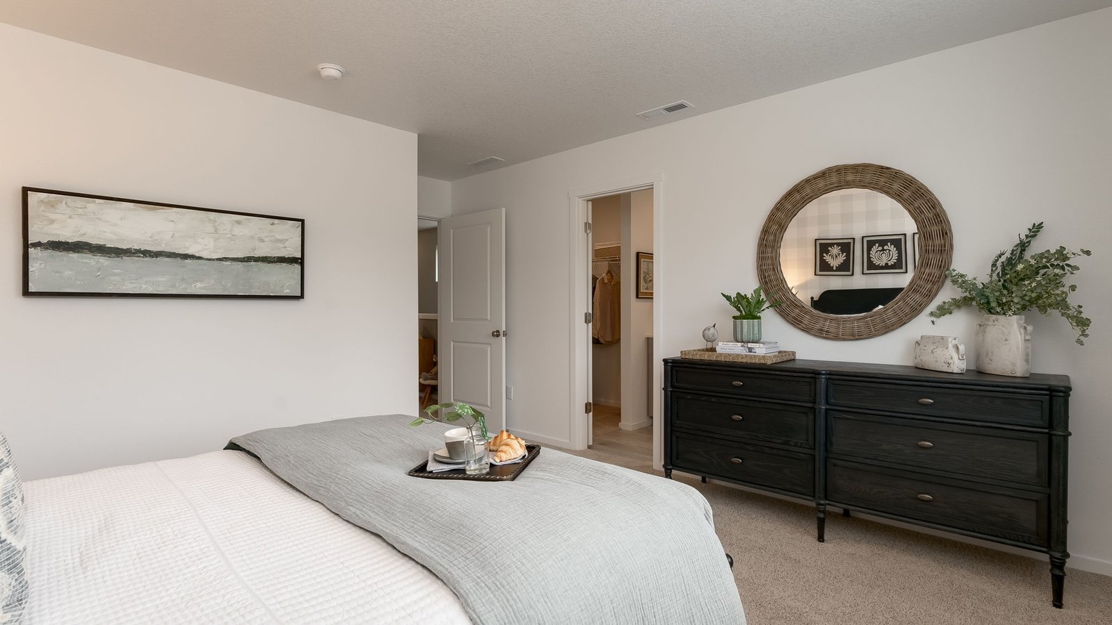 Primary bedroom with wall-to-wall carpet, a walk-in closet and an attached bathroom