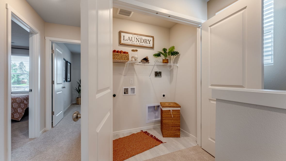 Laundry closet with wire shelves and washer and dryer hookups