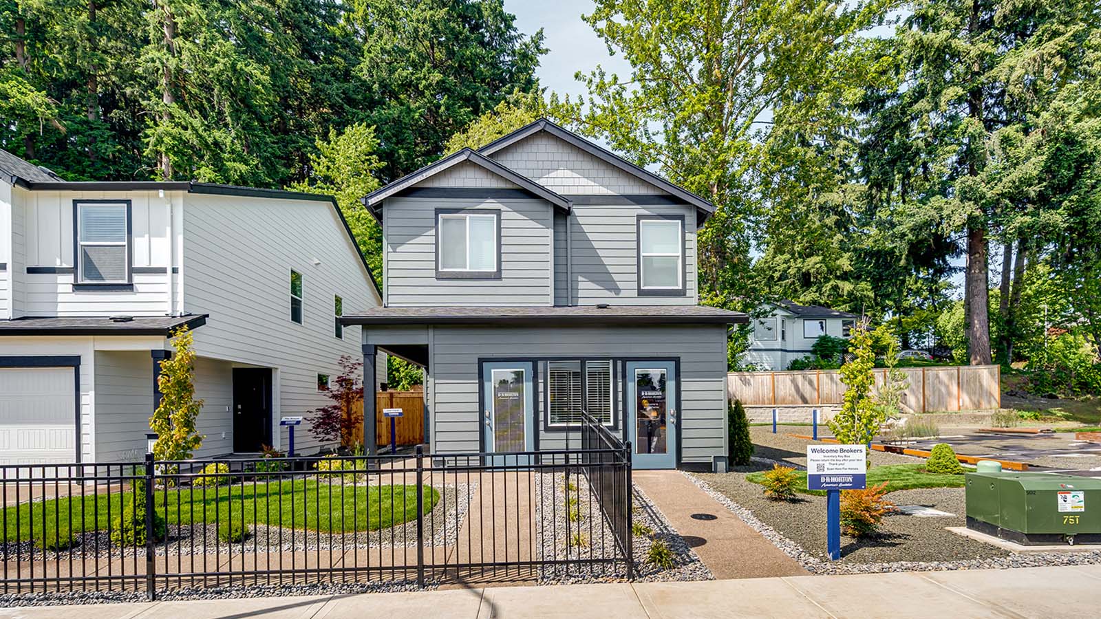 exterior front sales office of kunze farms, gray house with blue trim