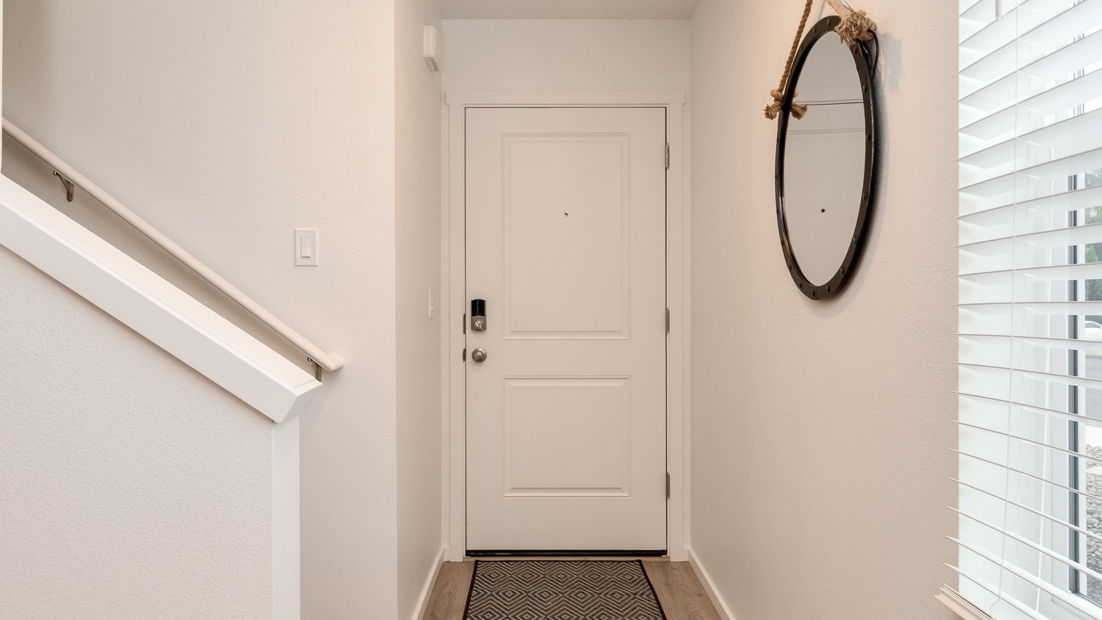 Entryway with a coat closet and laminate flooring