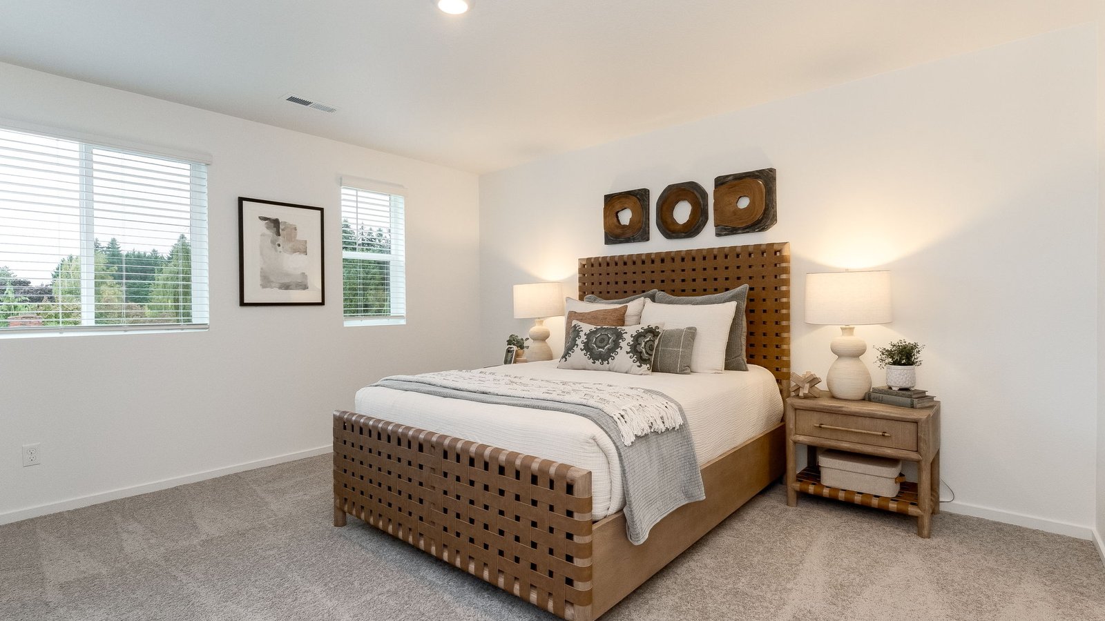 Primary bedroom with wall-to-wall carpet, a walk-in closet and an attached bathroom