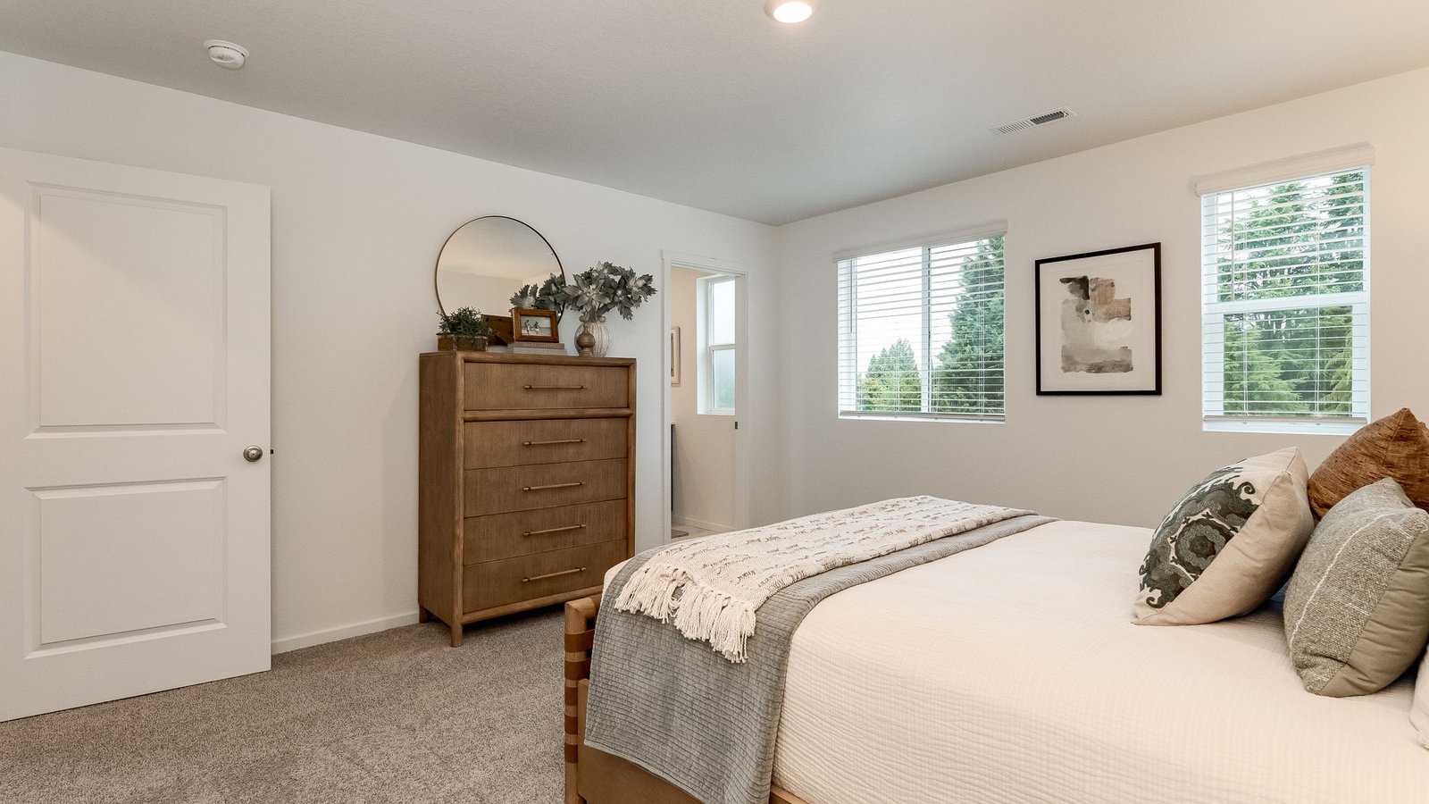 Primary bedroom with wall-to-wall carpet, a walk-in closet and an attached bathroom