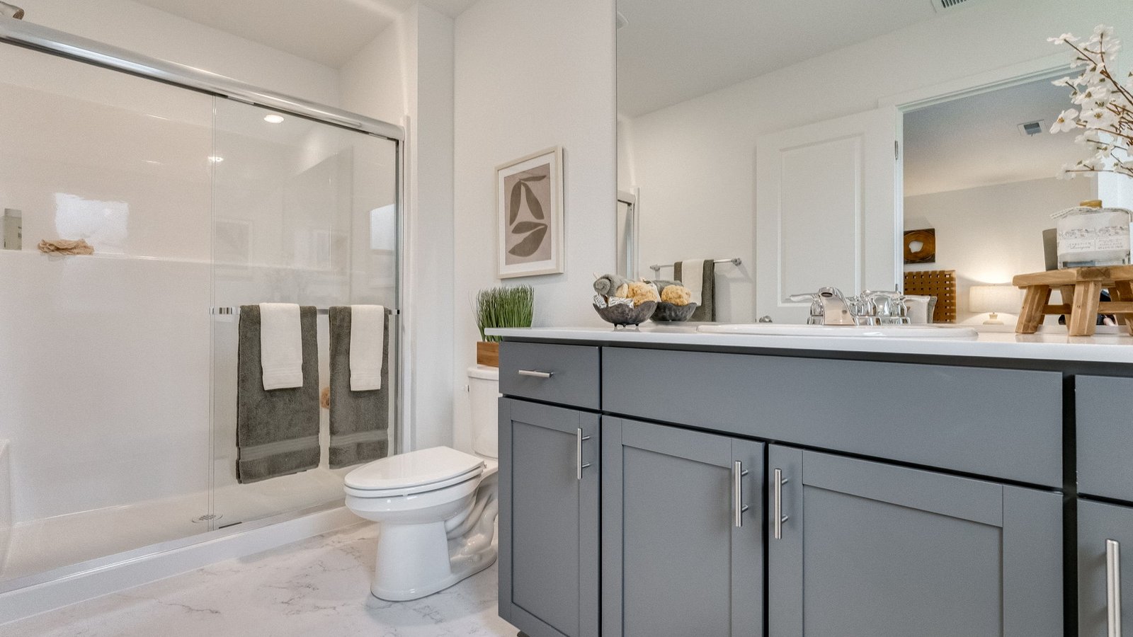 Primary bathroom with quartz counters and a walk-in shower