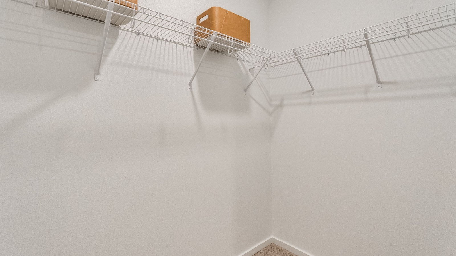 Primary bedroom walk-in closet with wire shelves