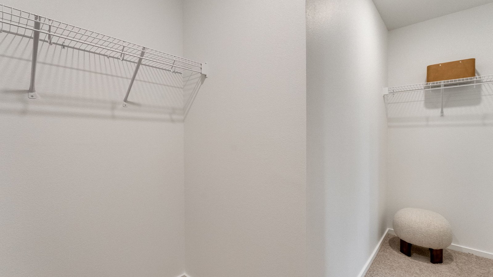 Primary bedroom walk-in closet with wire shelves