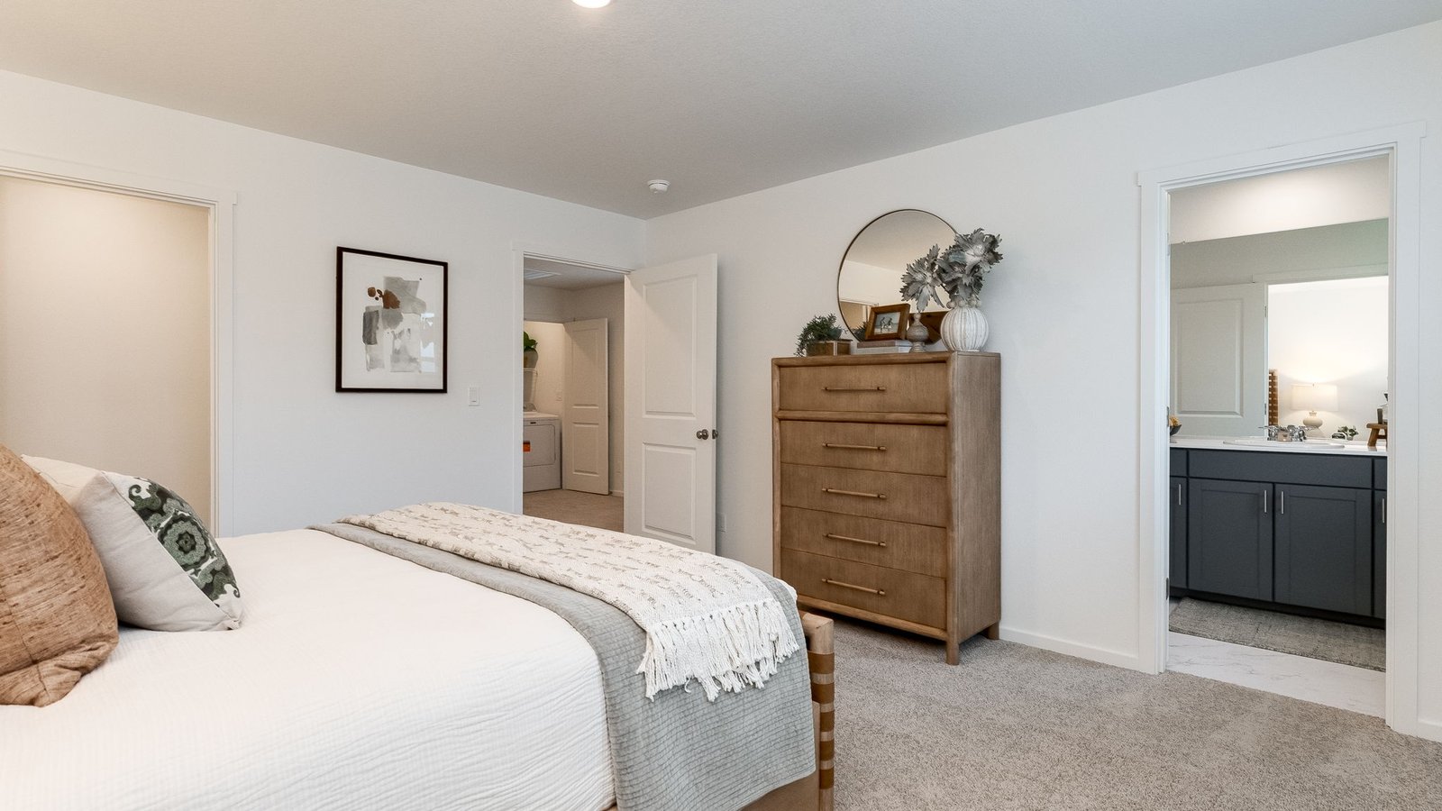 Primary bedroom with wall-to-wall carpet, a walk-in closet and an attached bathroom