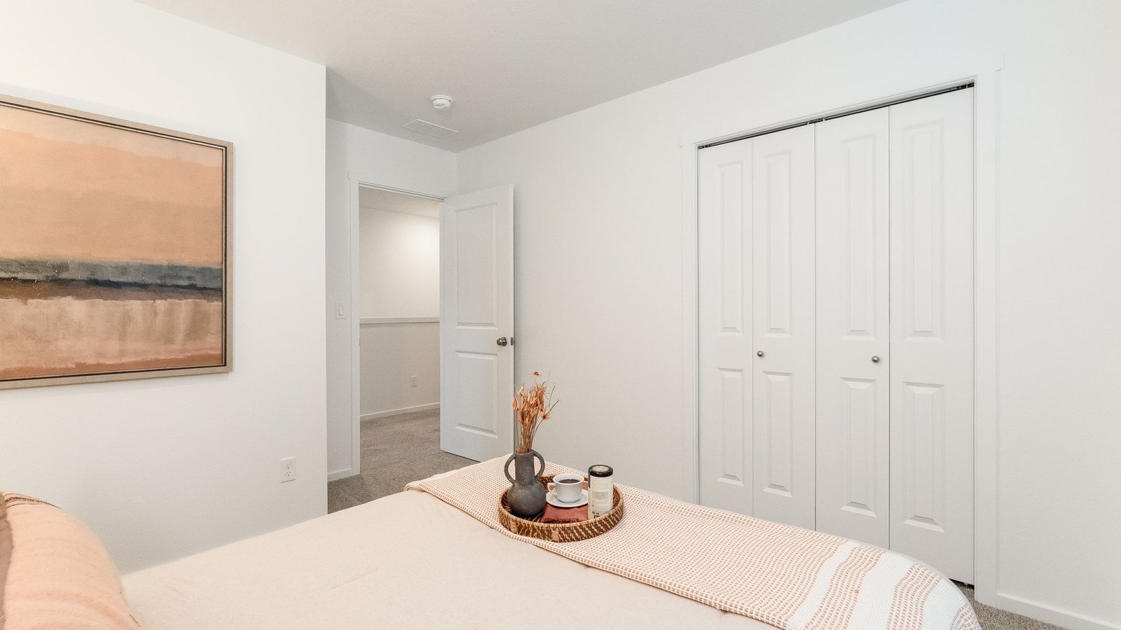 Bedroom with wall-to-wall carpet and a closet