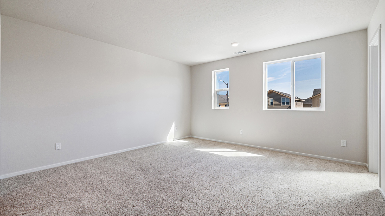 Primary bedroom with wall-to-wall carpet, a walk-in closet and an attached bathroom