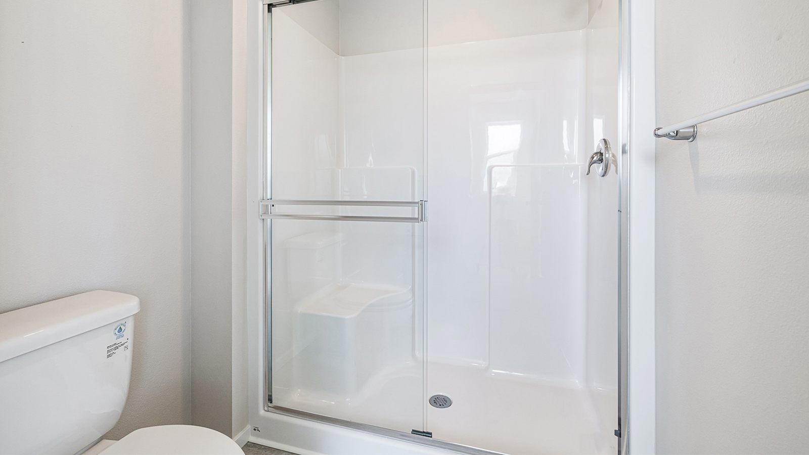 Primary bathroom with quartz counters and a walk-in shower