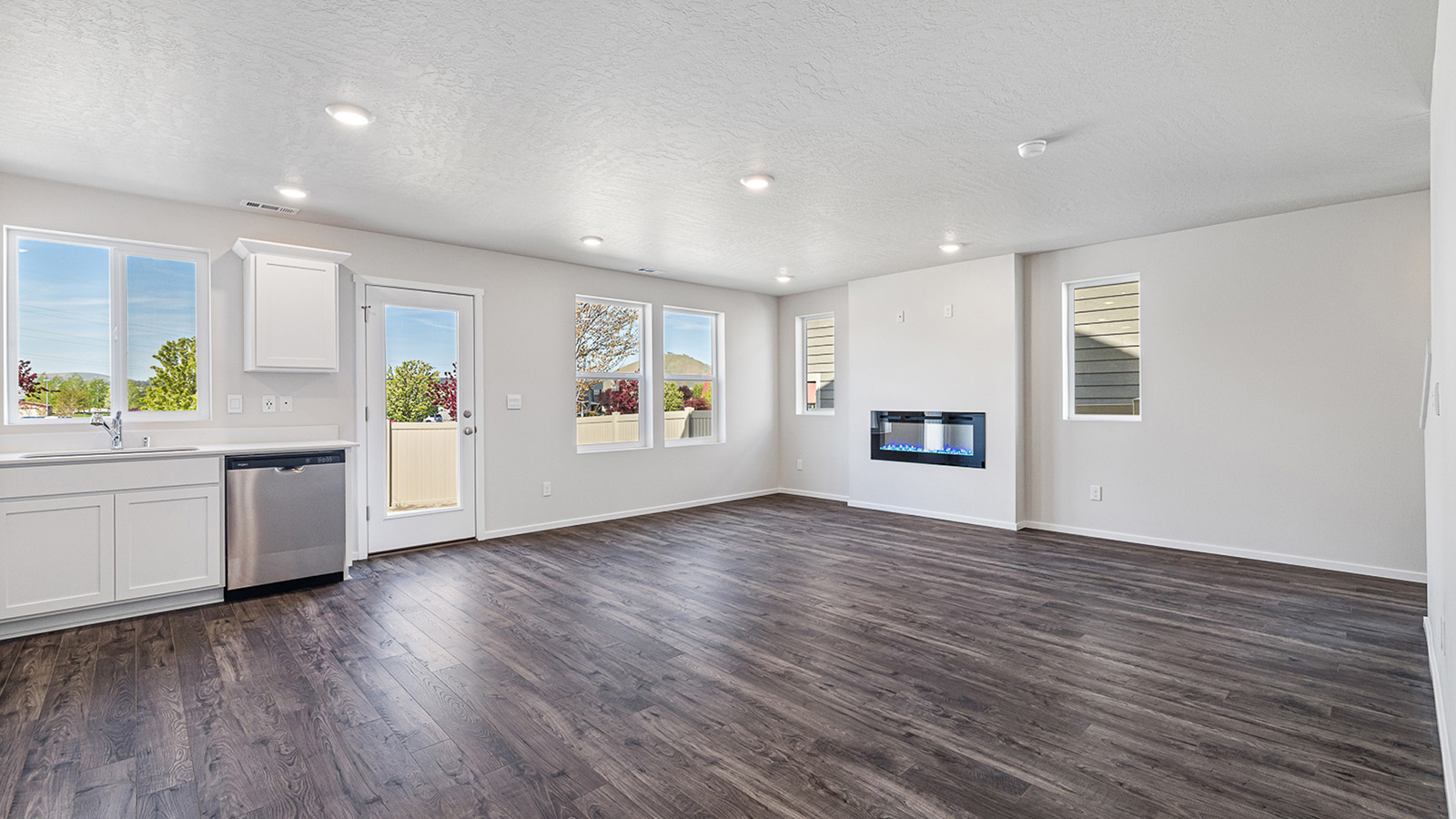 Great room with laminate flooring and an electric fireplace