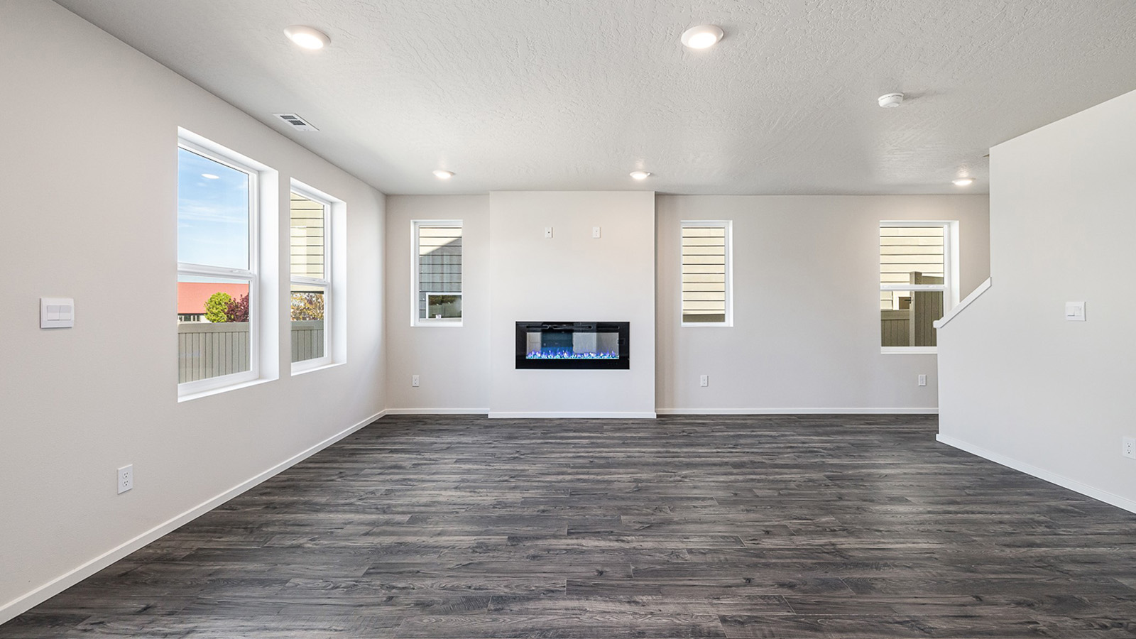 Great room with laminate flooring and an electric fireplace
