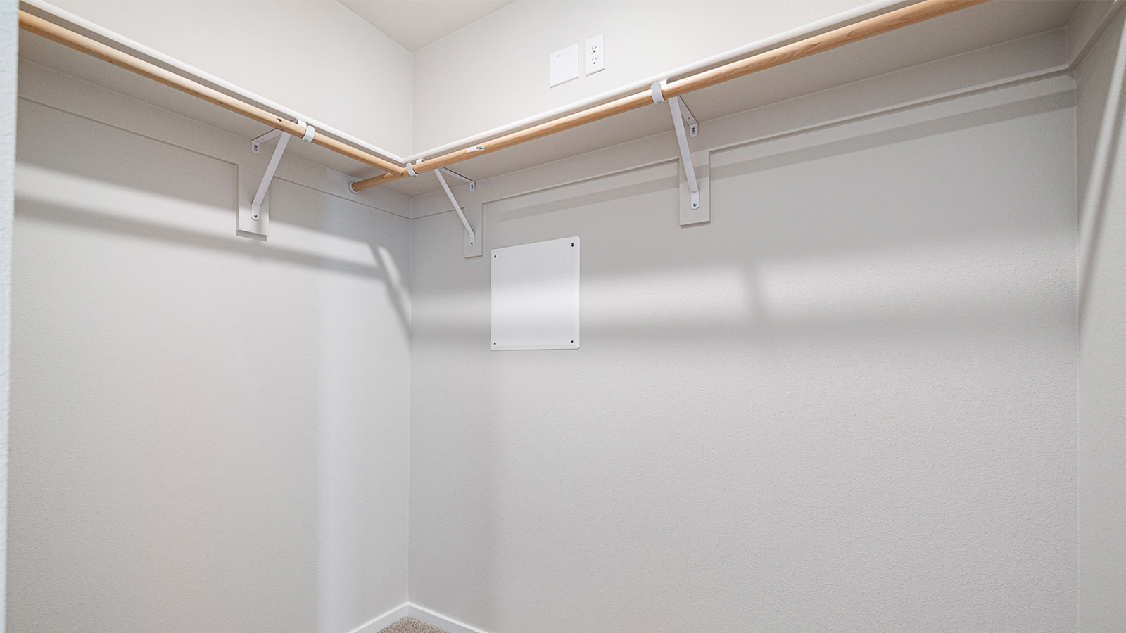 Primary bedroom walk-in closet with built-in shelves