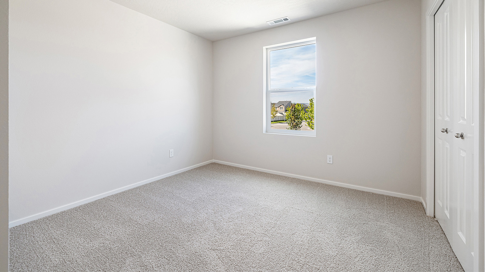Bedroom with wall-to-wall carpet and a closet