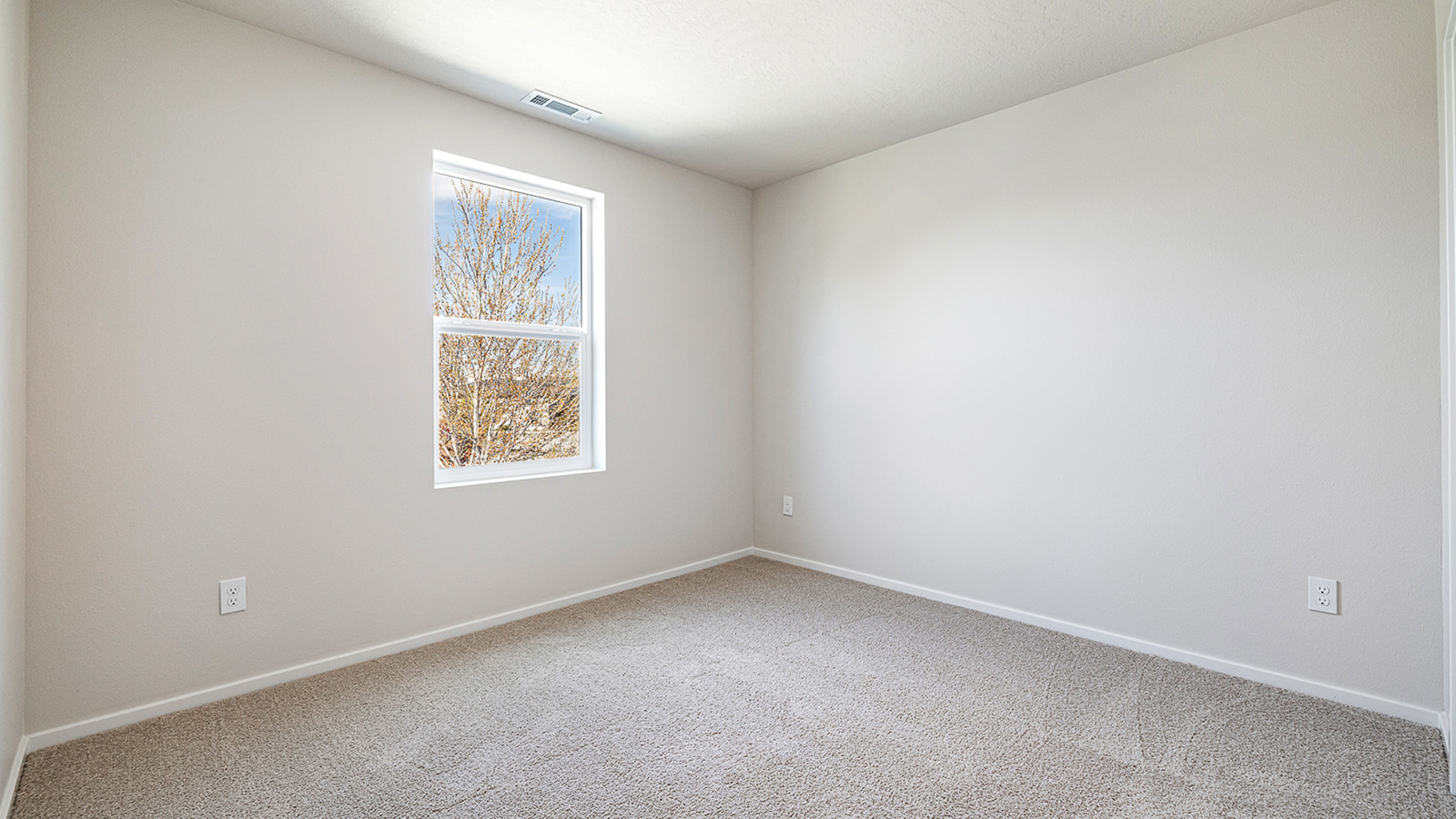 Bedroom with wall-to-wall carpet and a closet