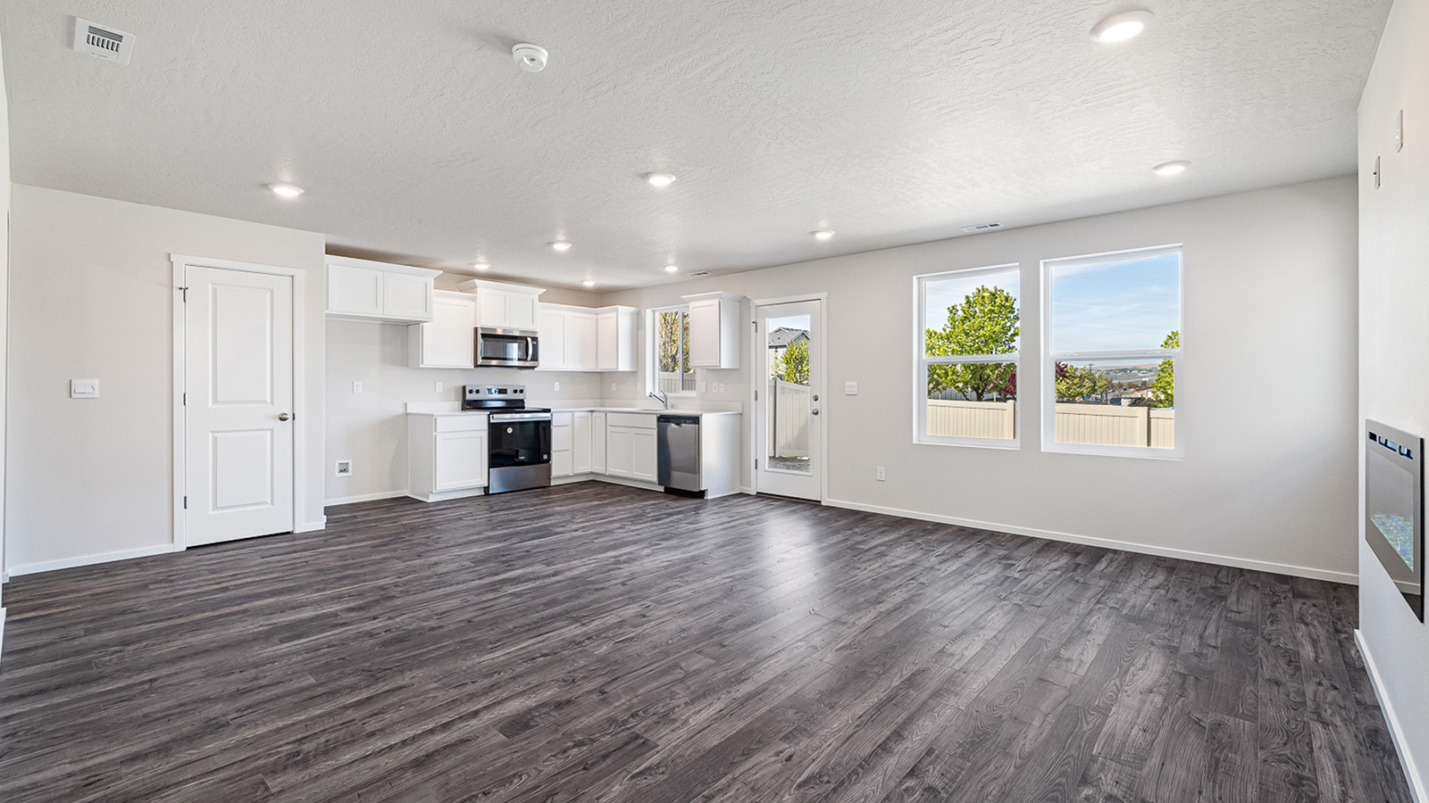 Great room with laminate flooring and an electric fireplace