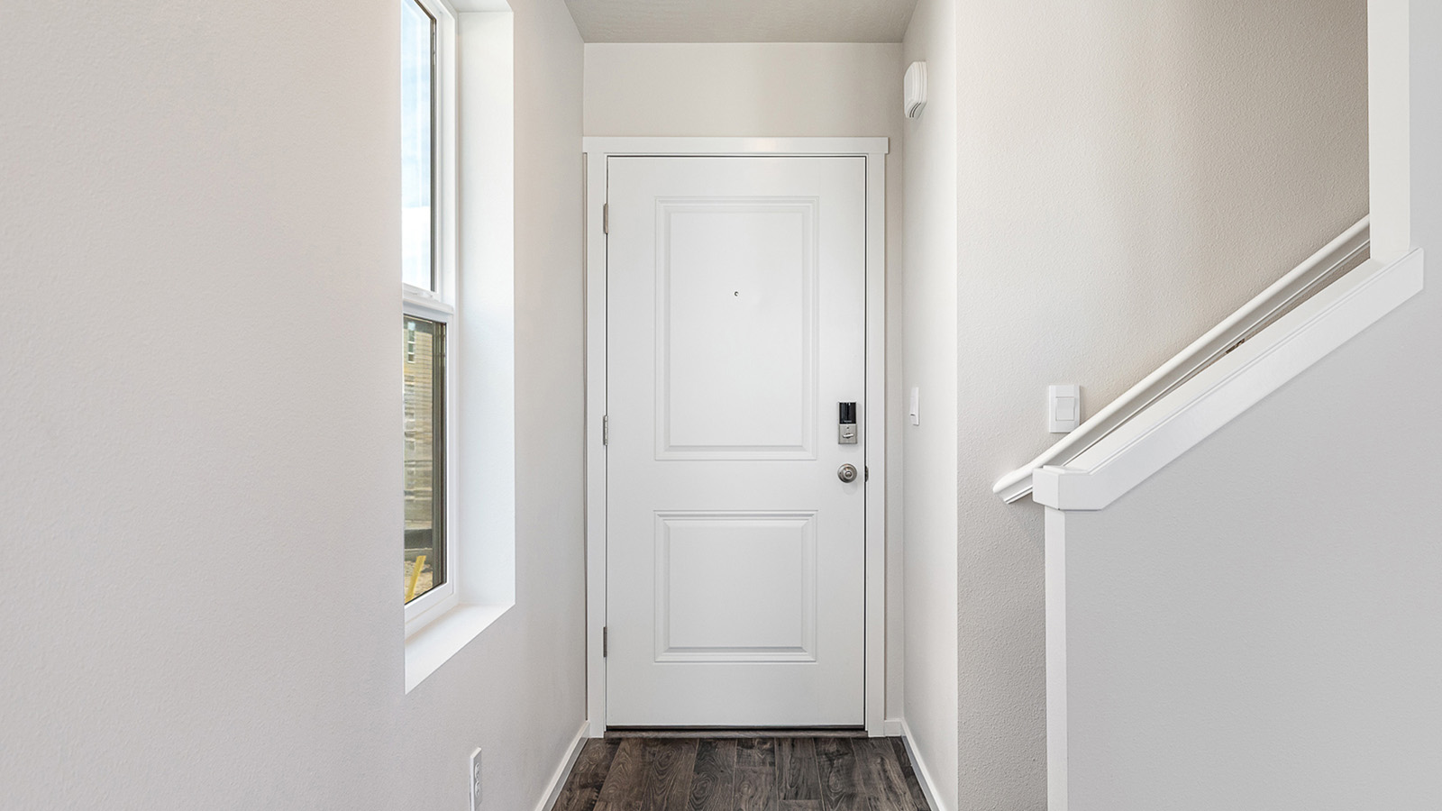 Entryway with a coat closet and laminate flooring