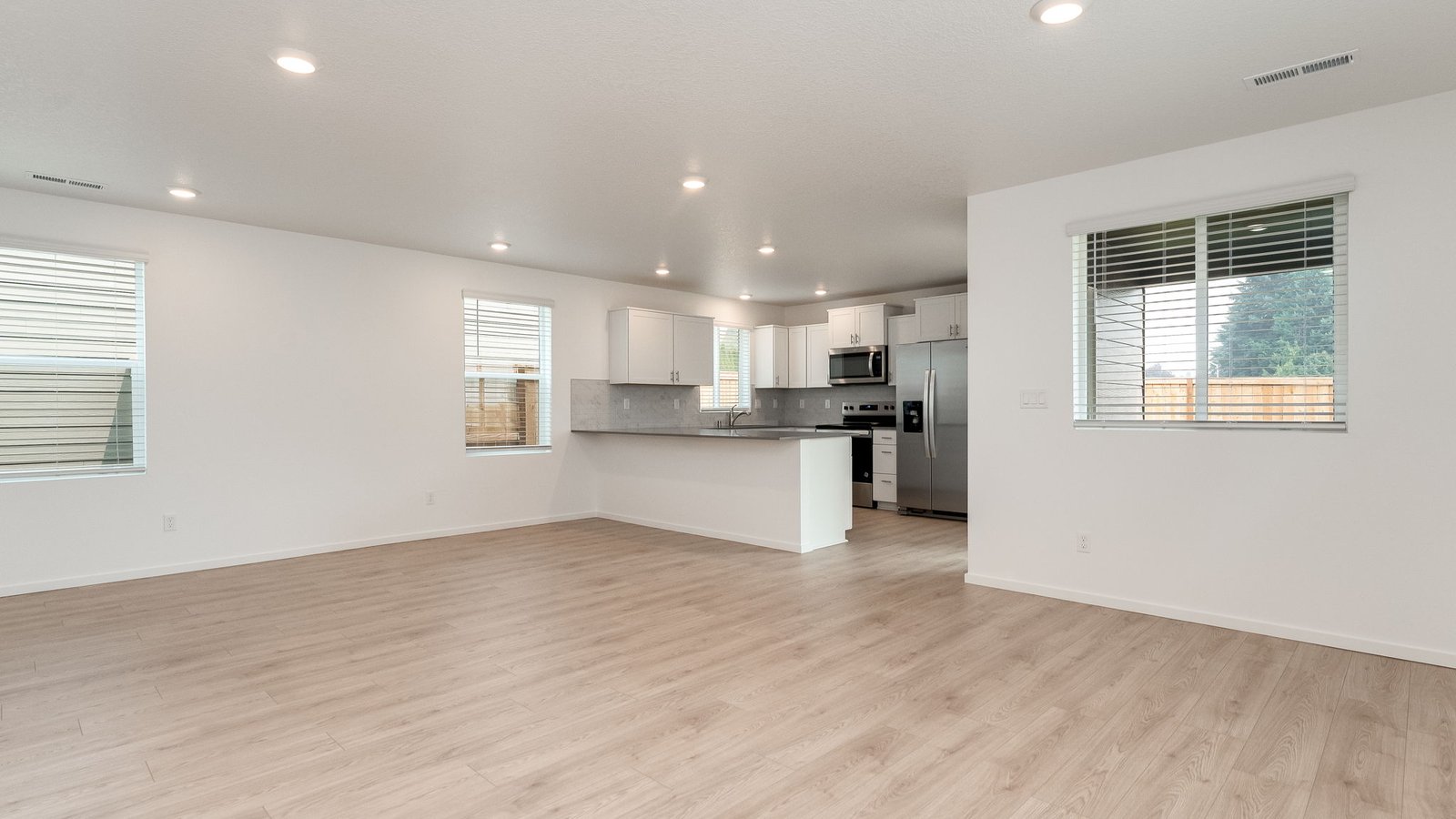Great room with laminate flooring and an electric fireplace