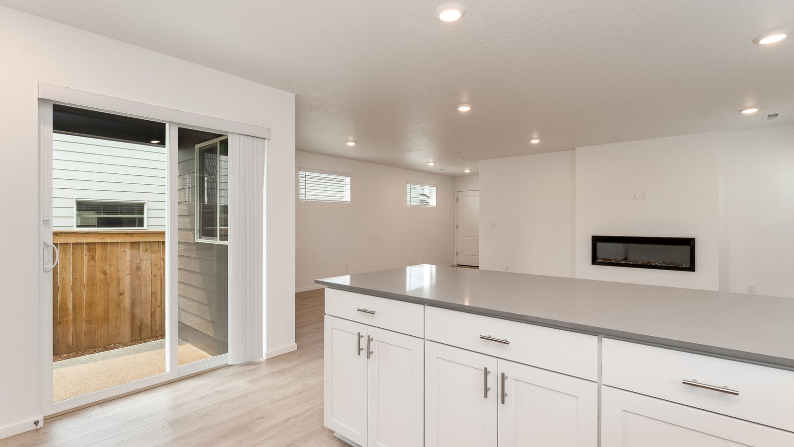 U-shaped kitchen with shaker cabinets, quartz counters, stainless steel appliances, pantry, and a breakfast bar
