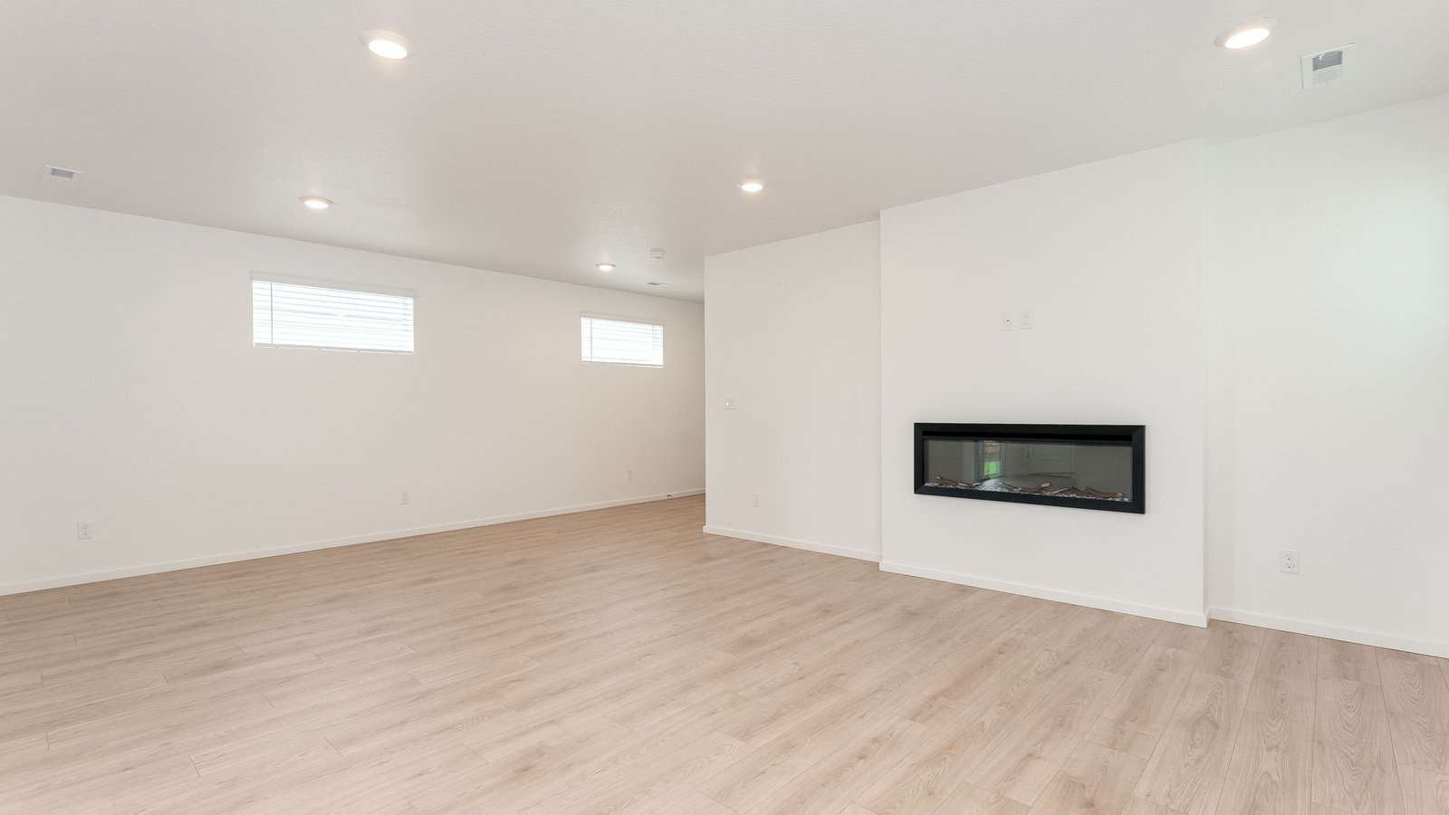 Great room with laminate flooring and an electric fireplace