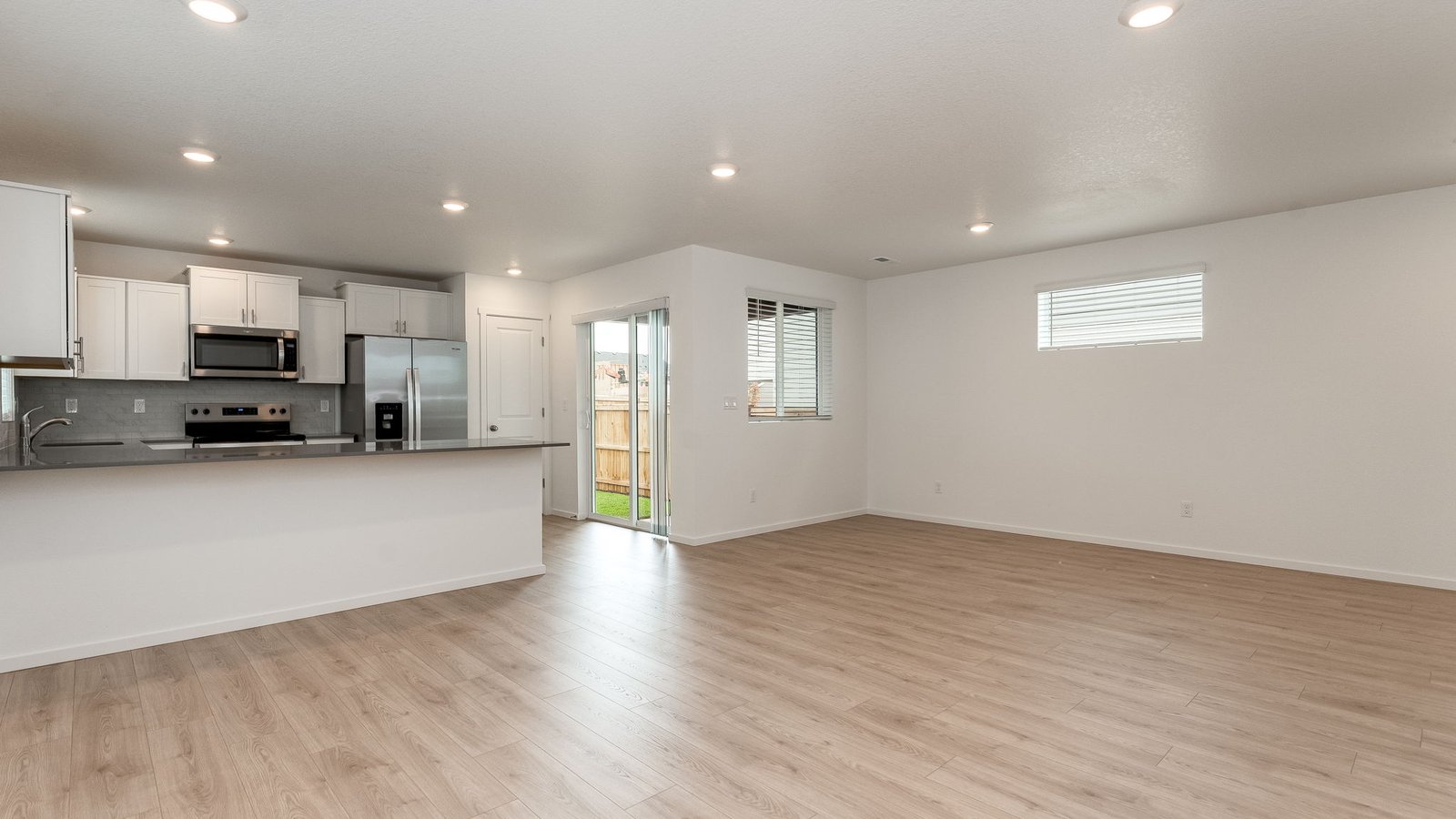 Great room with laminate flooring and an electric fireplace