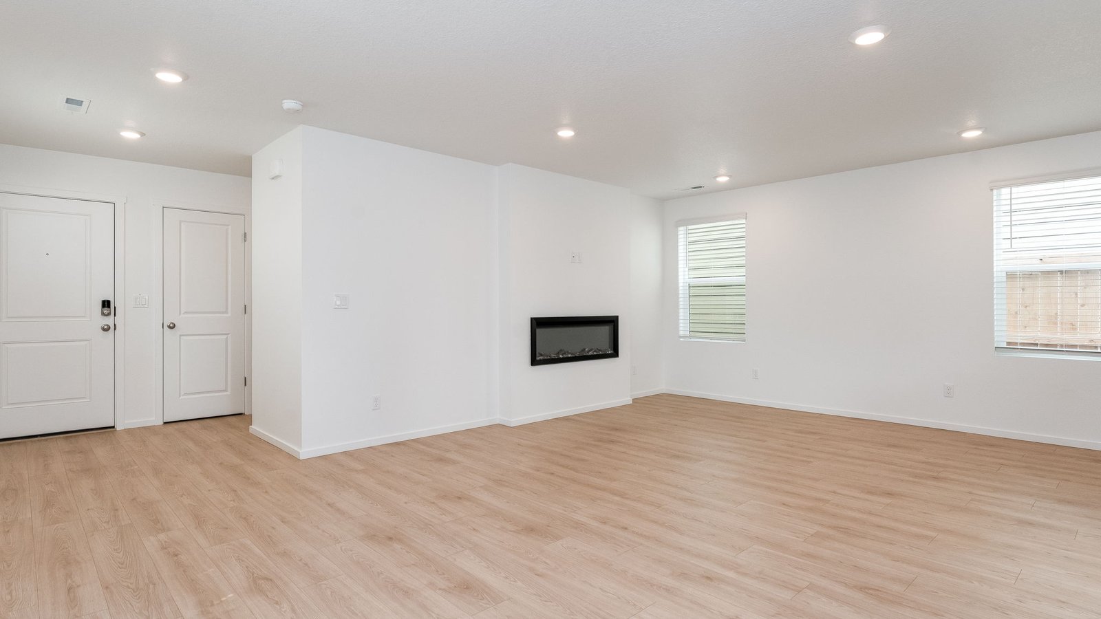 Great room with laminate flooring and an electric fireplace