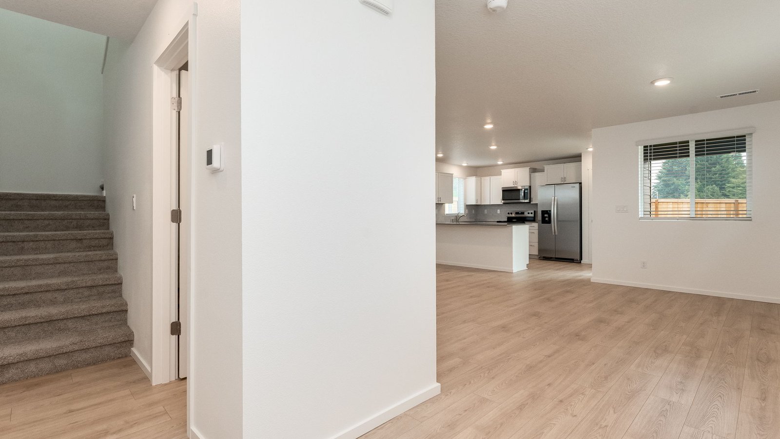 Entryway with a coat closet and laminate flooring