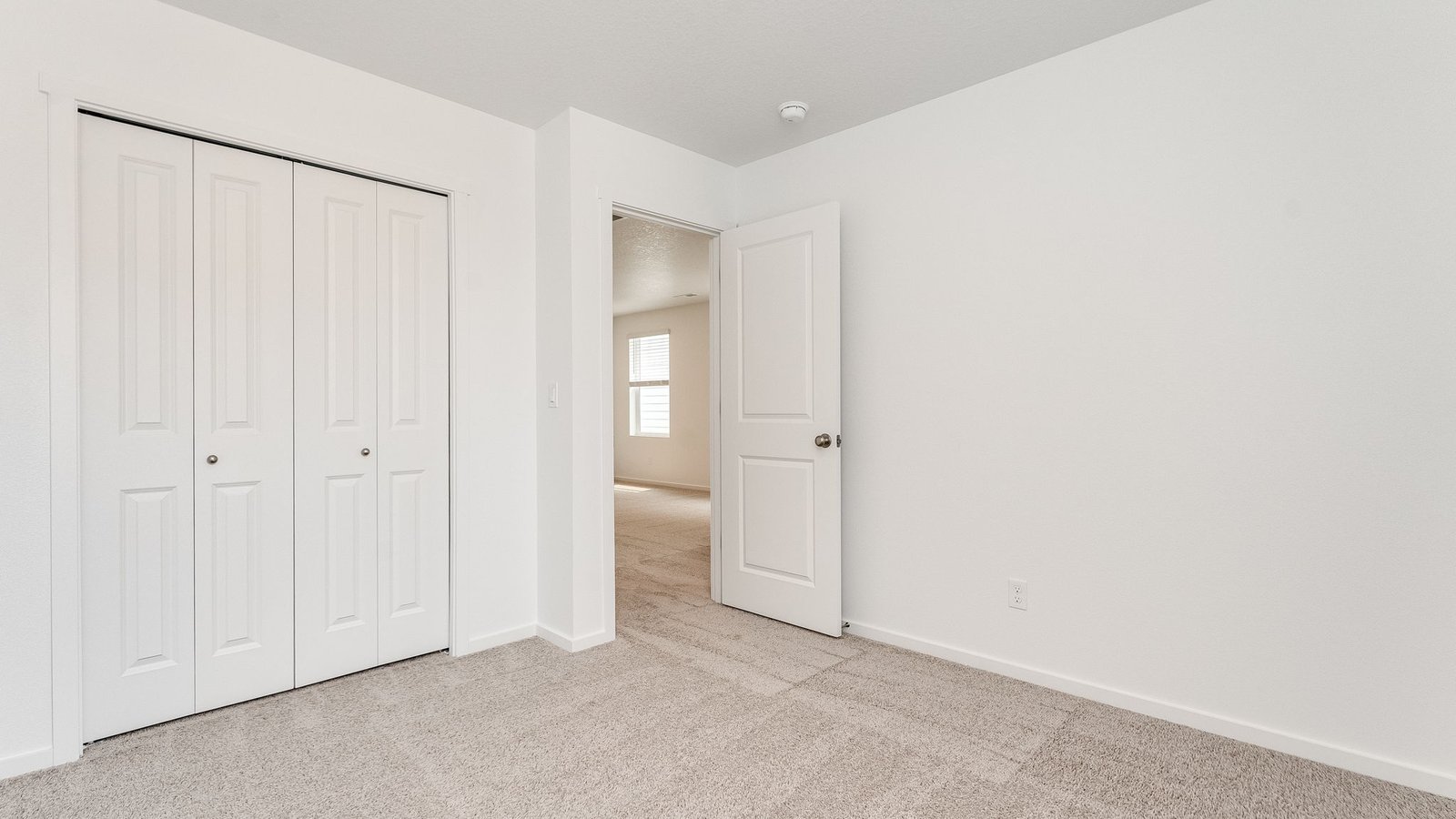 Bedroom with wall-to-wall carpet and a closet