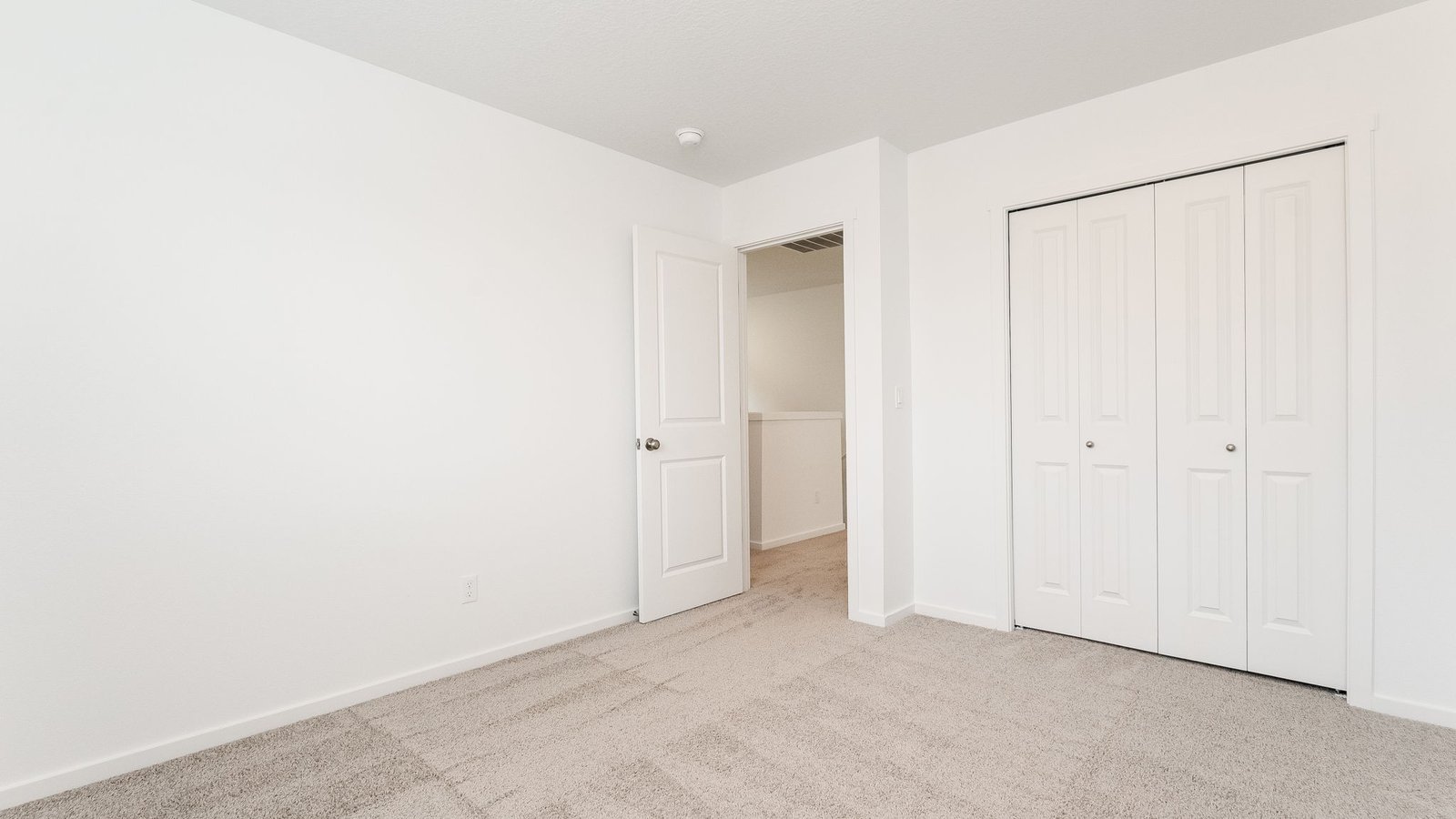 Bedroom with wall-to-wall carpet and a closet