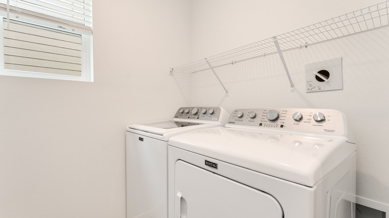 Laundry room with wire shelves and washer and dryer hookups