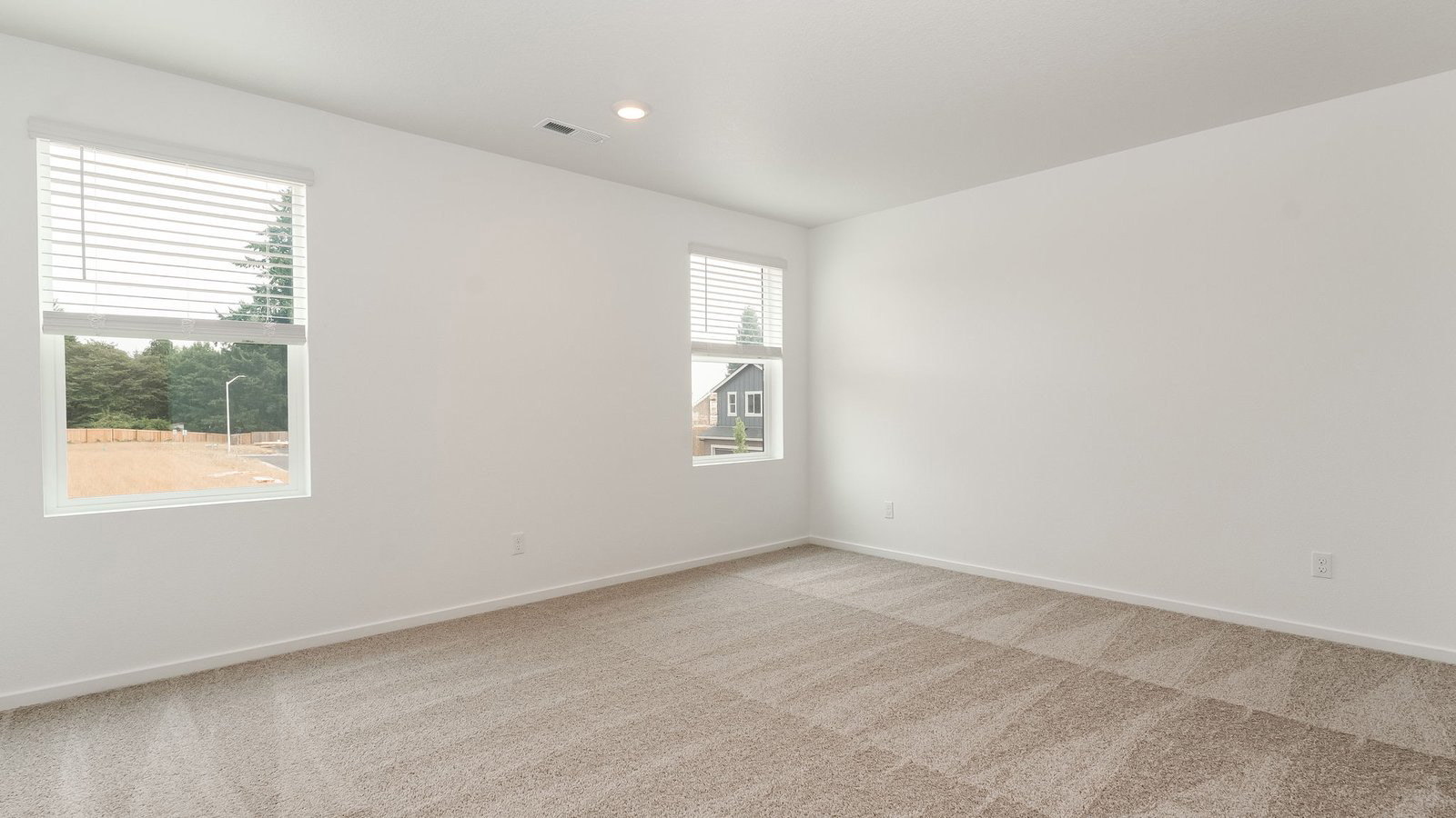 Primary bedroom with wall-to-wall carpet, a walk-in closet and an attached bathroom