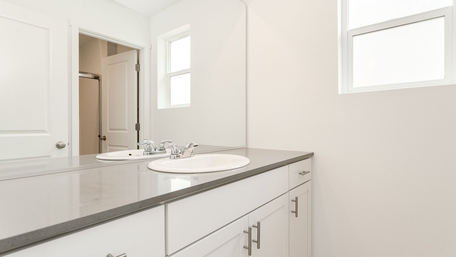 Primary bathroom with quartz counters and a walk-in shower