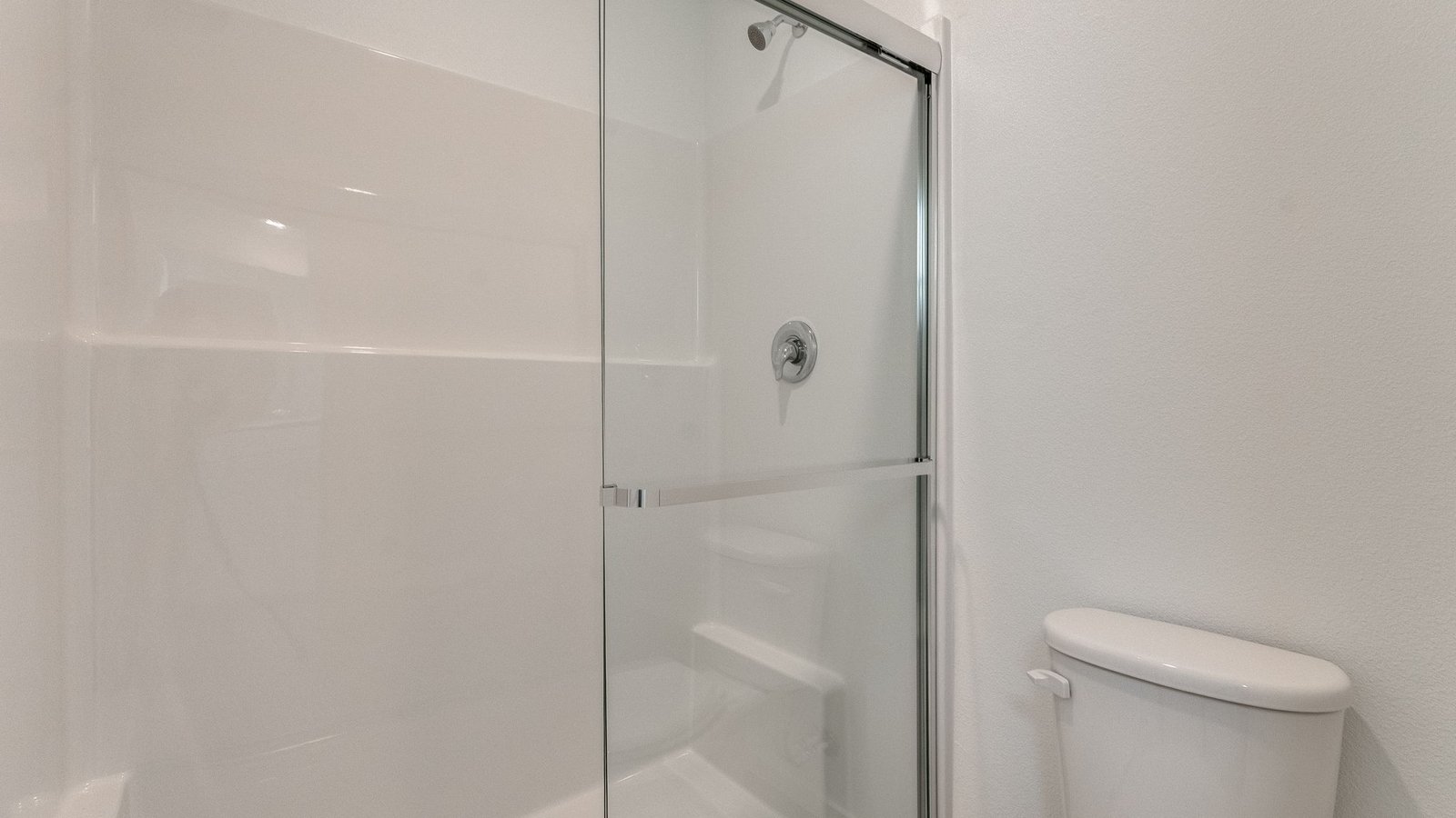 Primary bathroom with quartz counters and a walk-in shower