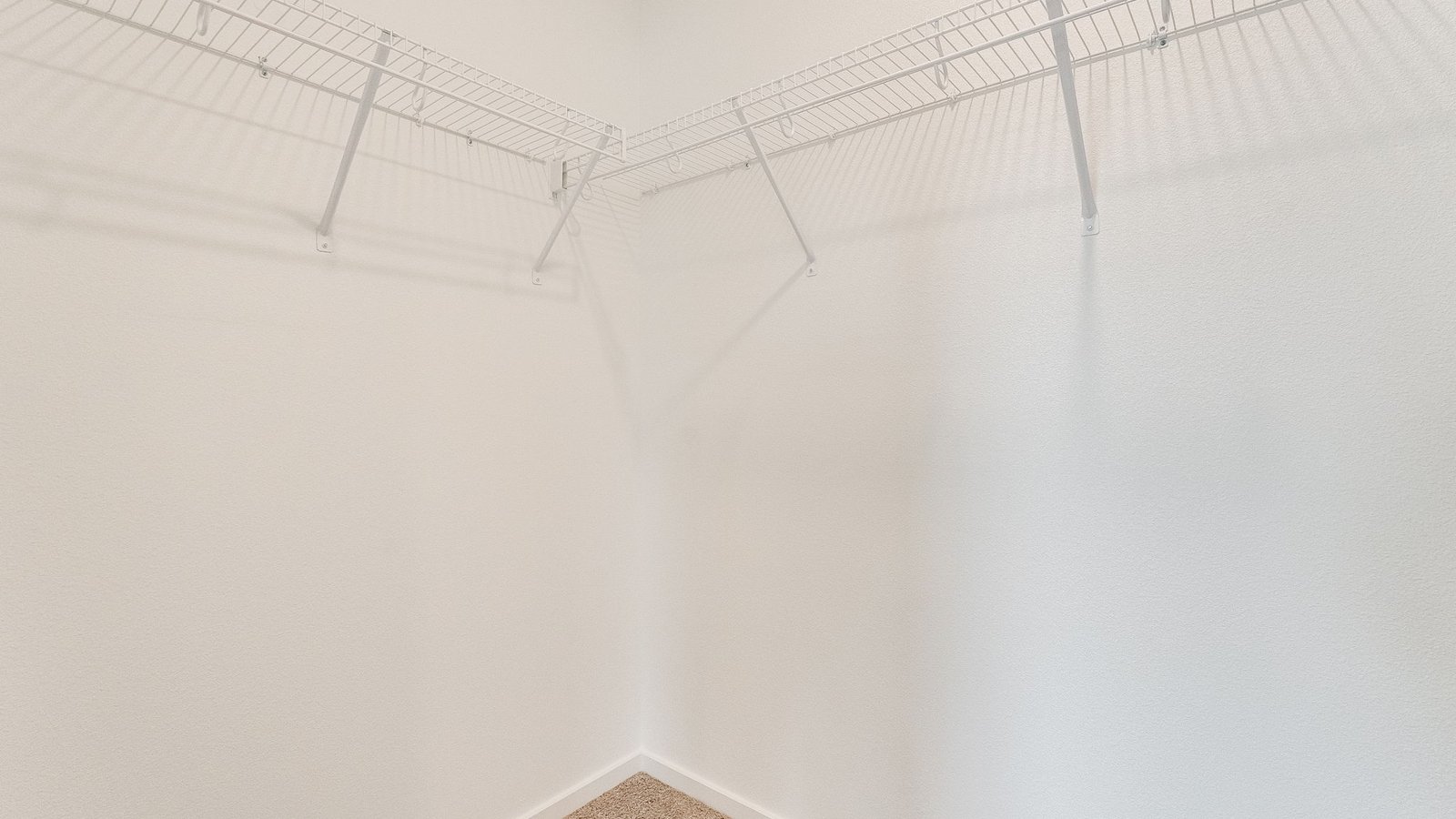 Primary bedroom walk-in closet with wire shelves