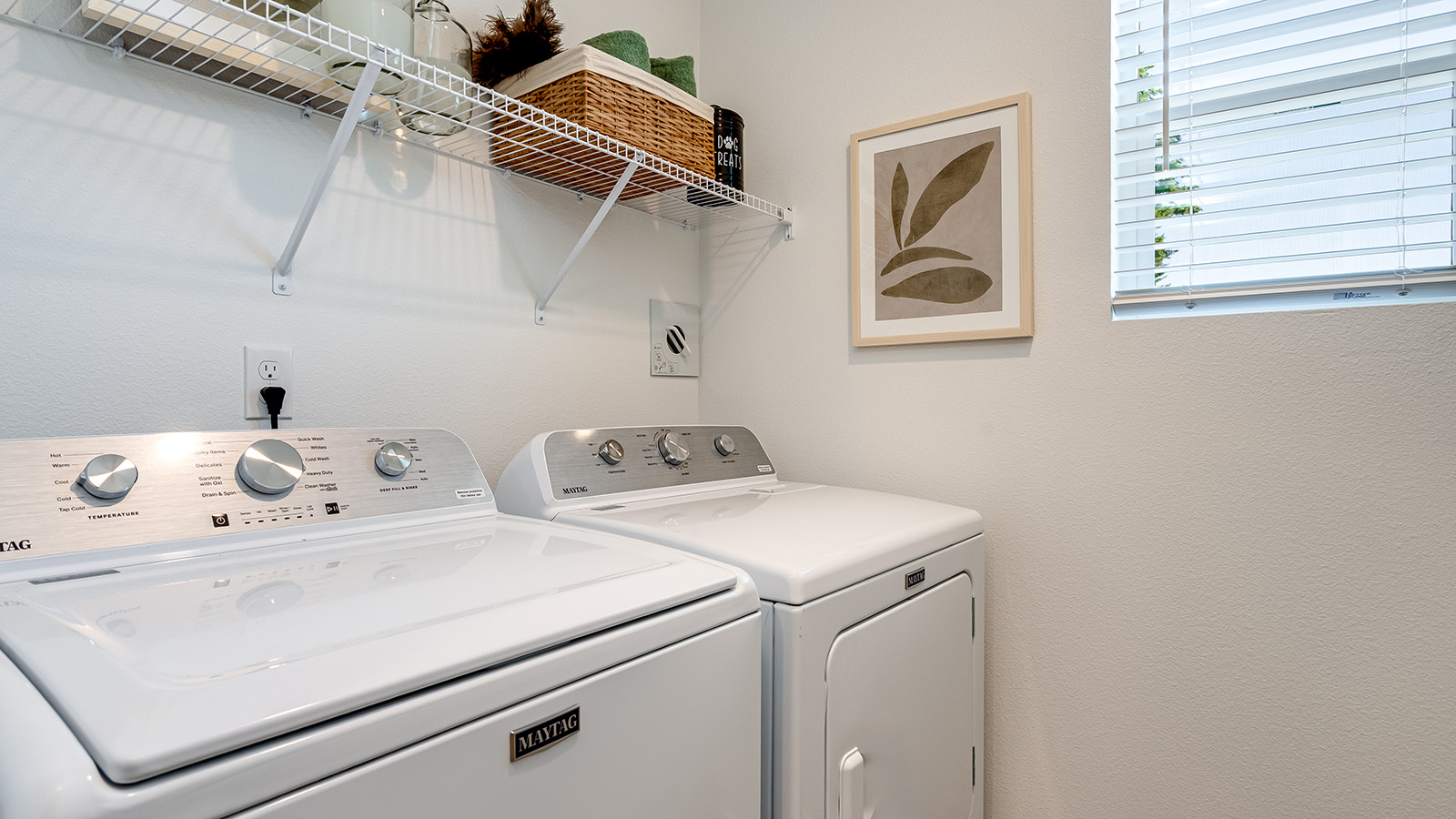 Laundry room with wire shelves and washer and dryer hookups