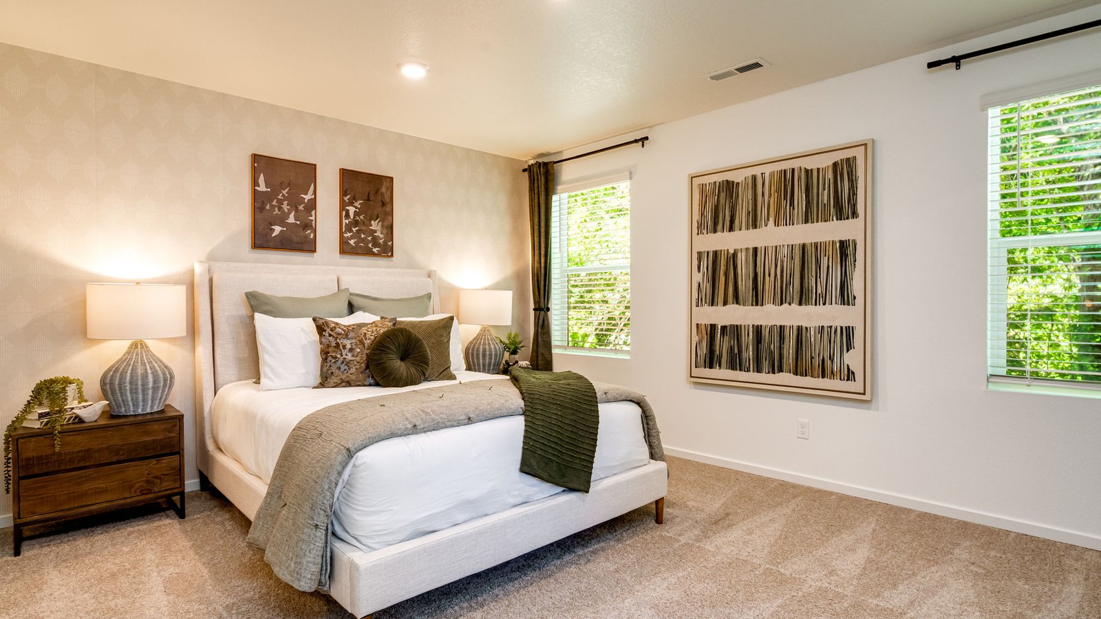 Primary bedroom with wall-to-wall carpet, a walk-in closet and an attached bathroom